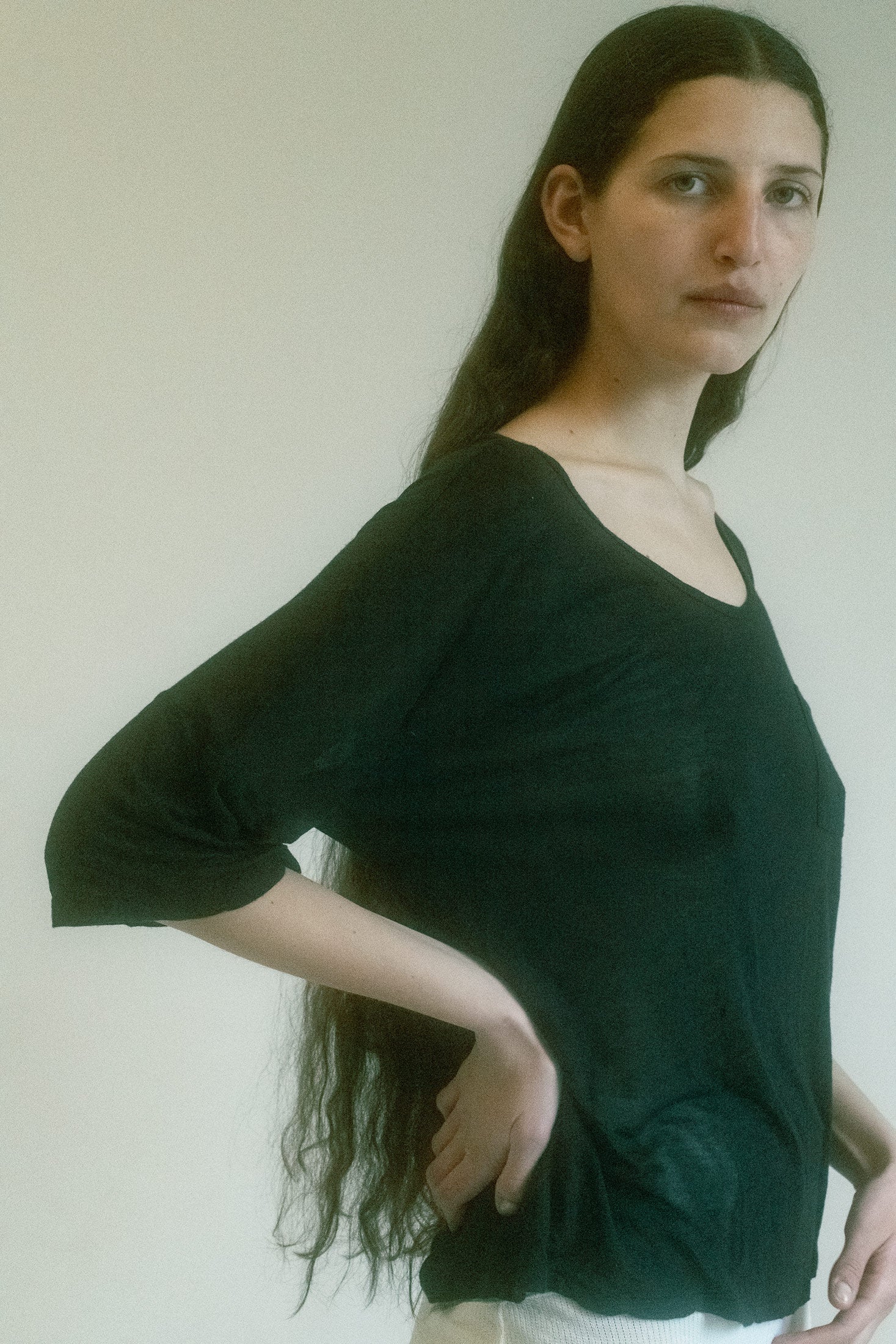The fabric, thin and soft as a sigh, drapes over the body with a semi-sheer transparency that invites curiosity, while maintaining an air of mystery.