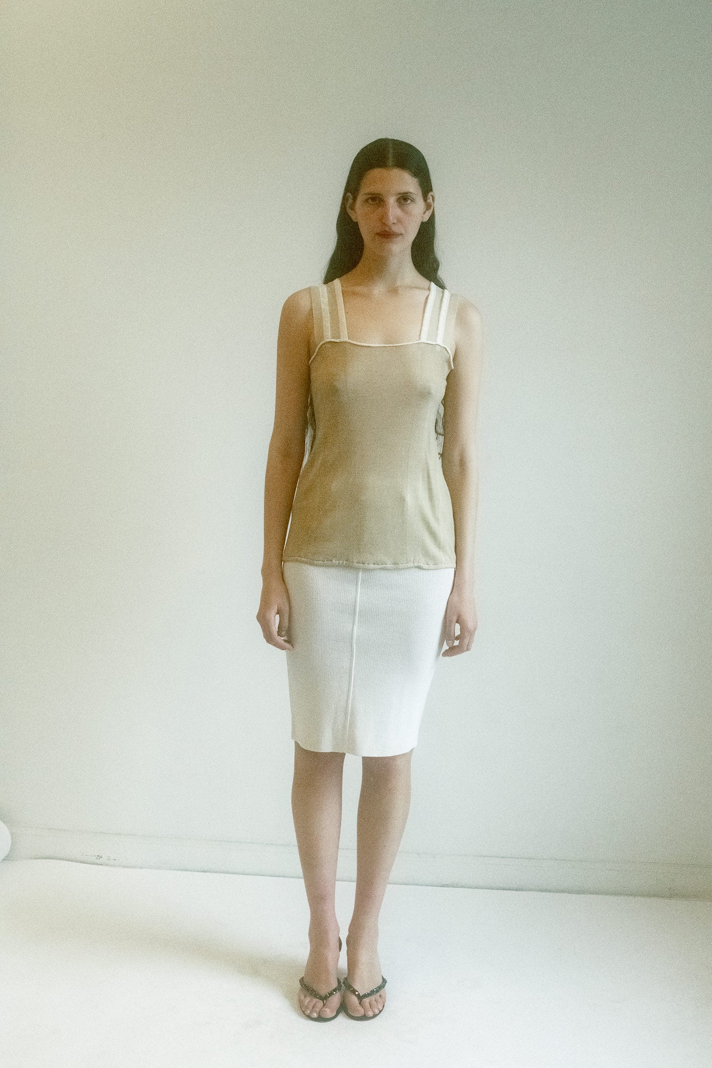 The body is a soft knit, hugging just close enough to hint.