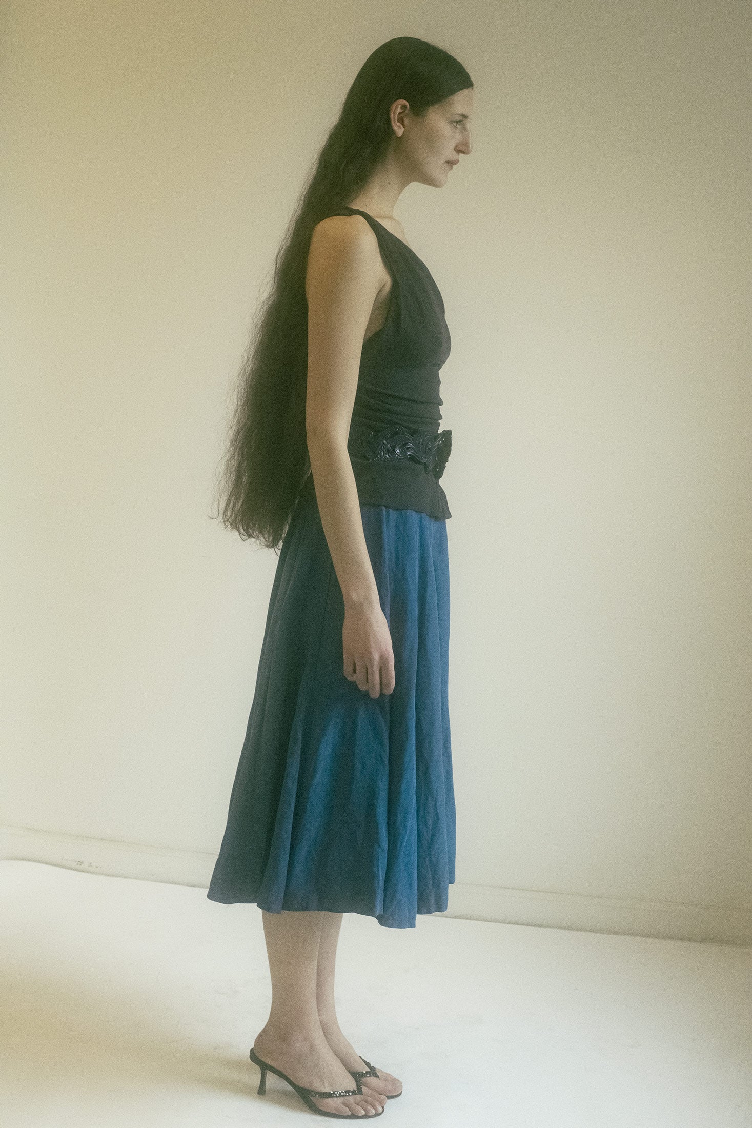 A button side closure at the waist—an understated detail, almost like a secret handshake between you and the skirt, saying, Yes, we’re both part of something bigger.