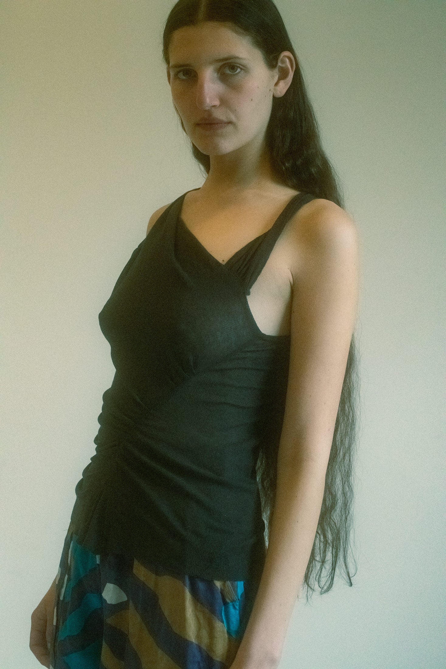The Isabel Marant Asymmetric Ruched Tank is the perfect fusion of effortless chic and alluring mystery.