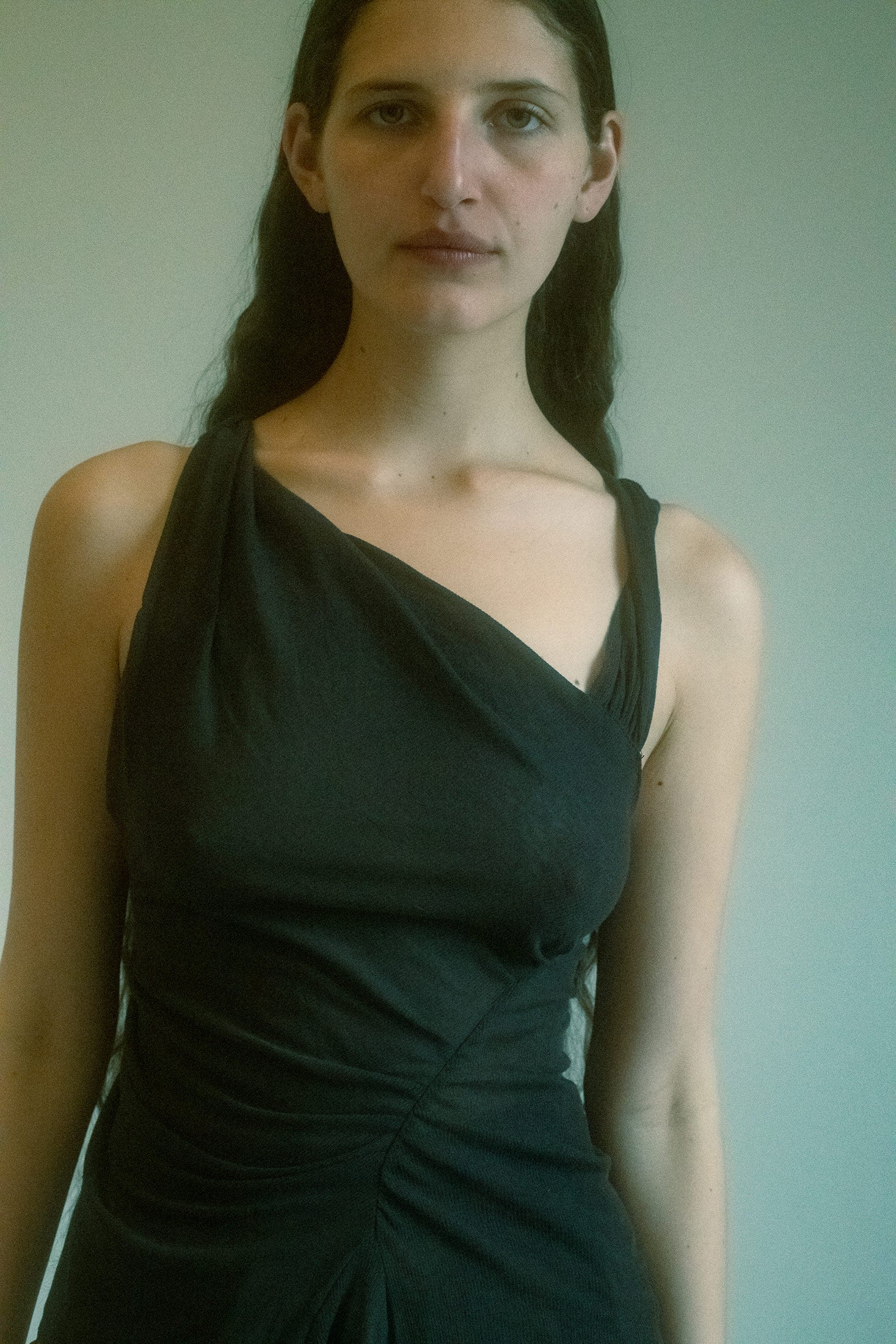 Crafted from a lightweight, sheer fabric, this tank top drapes delicately over the body, offering a soft, ethereal quality that catches the light with every movement.