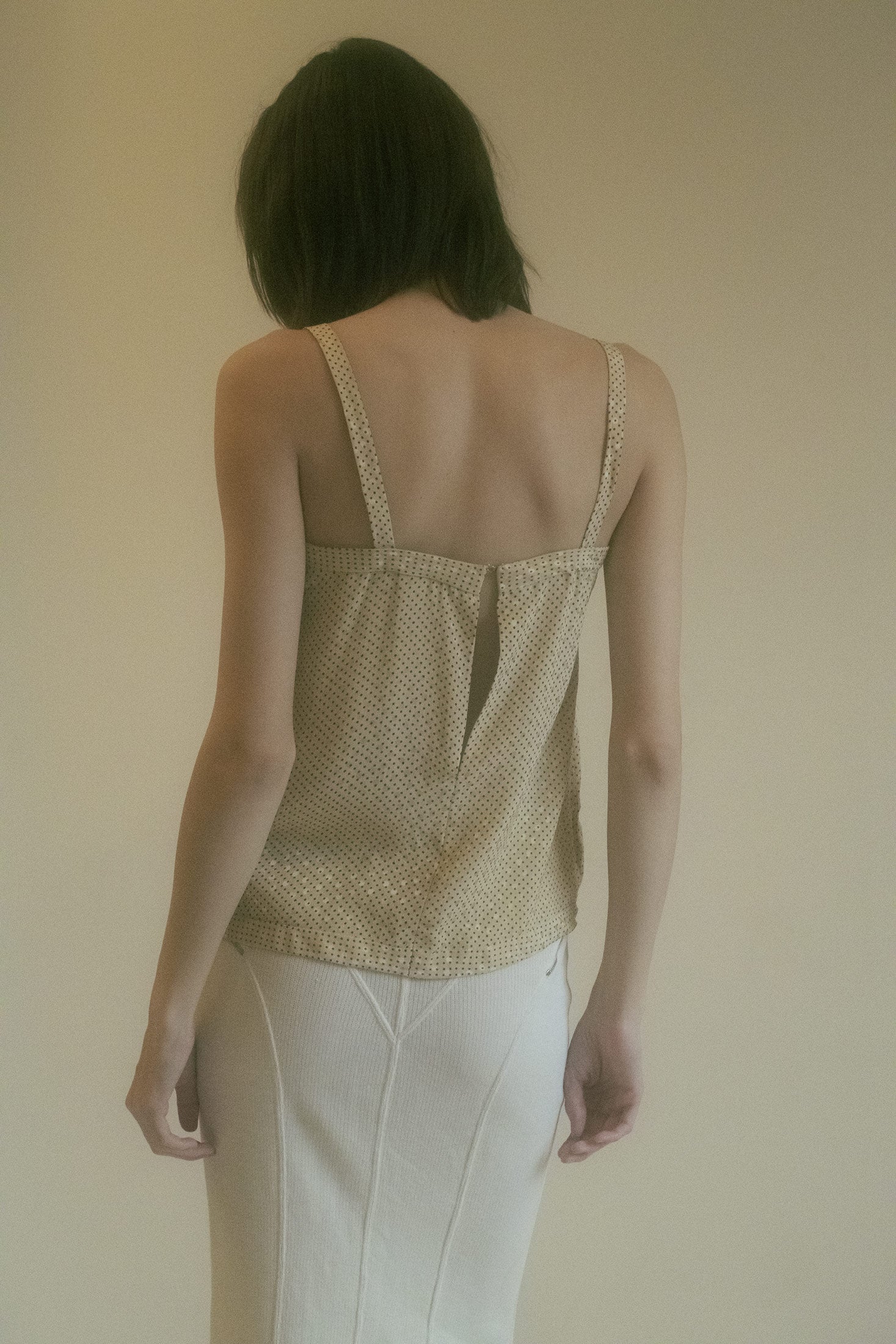 Unique and dynamic, this top brings a timeless, cinematic elegance to any outfit.