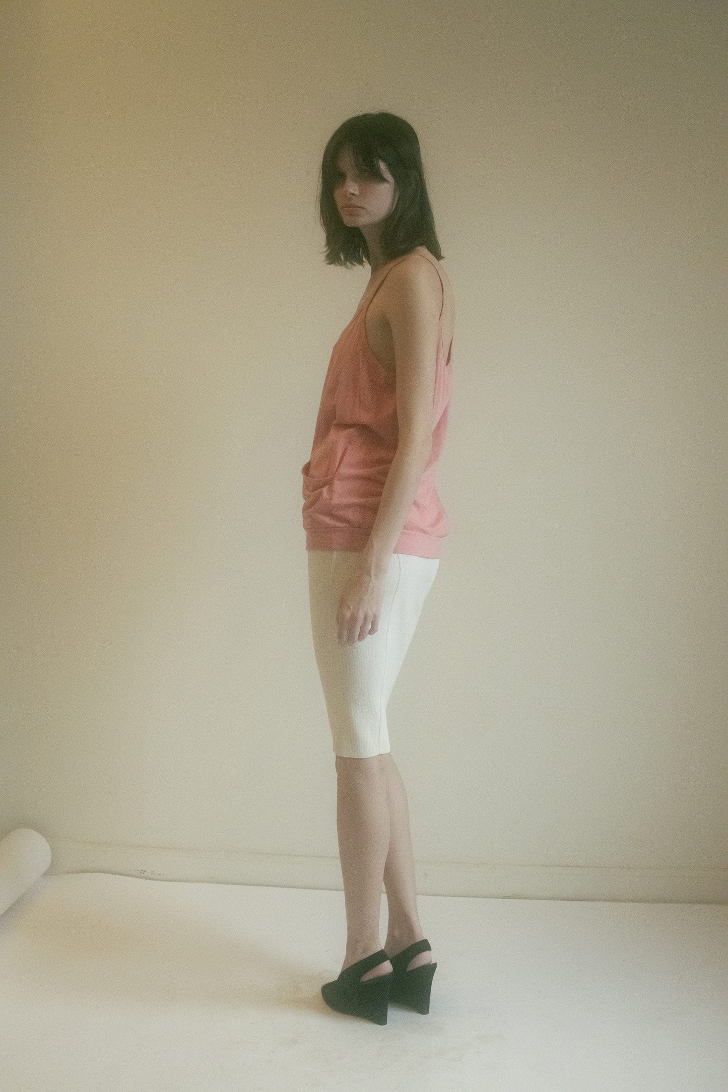The low waistband drapes just-so, slouchy and sly. Like she’s been up to something, and the tank knows it.