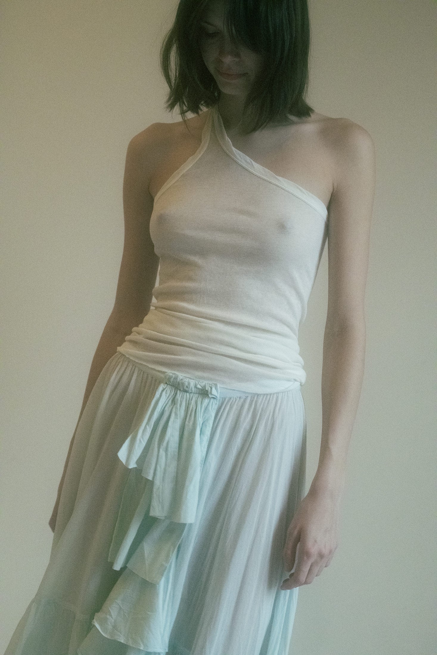 Fitted yet liberating, it drapes against the body with a grace that invites curiosity and holds it captive in its understated yet potent charm.