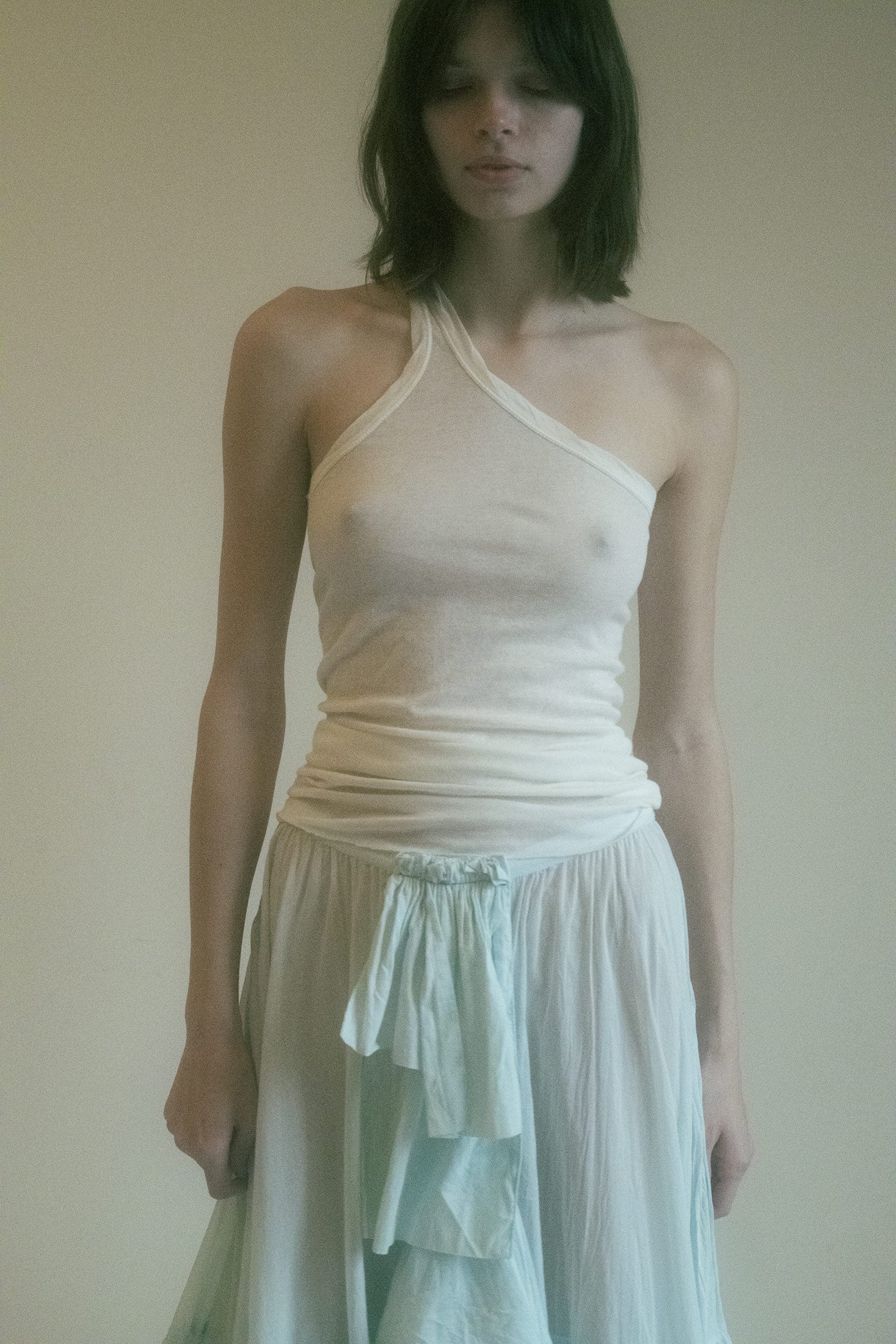 A masterstroke of minimalist allure, this one-shoulder top by Rick Owens is the embodiment of quiet rebellion.
