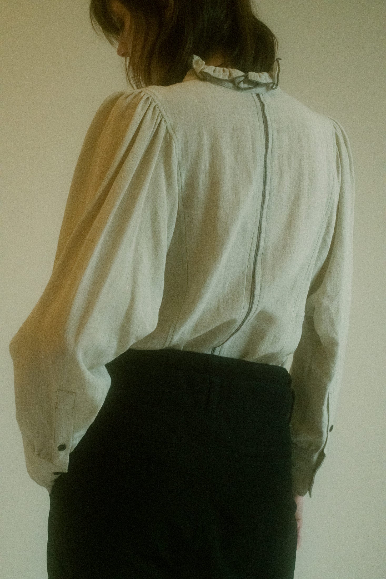 The high neck and fitted silhouette exude a sense of both mystery and confidence, while the soft fabric and sensual lines create an ethereal quality that feels both modern and cinematic.