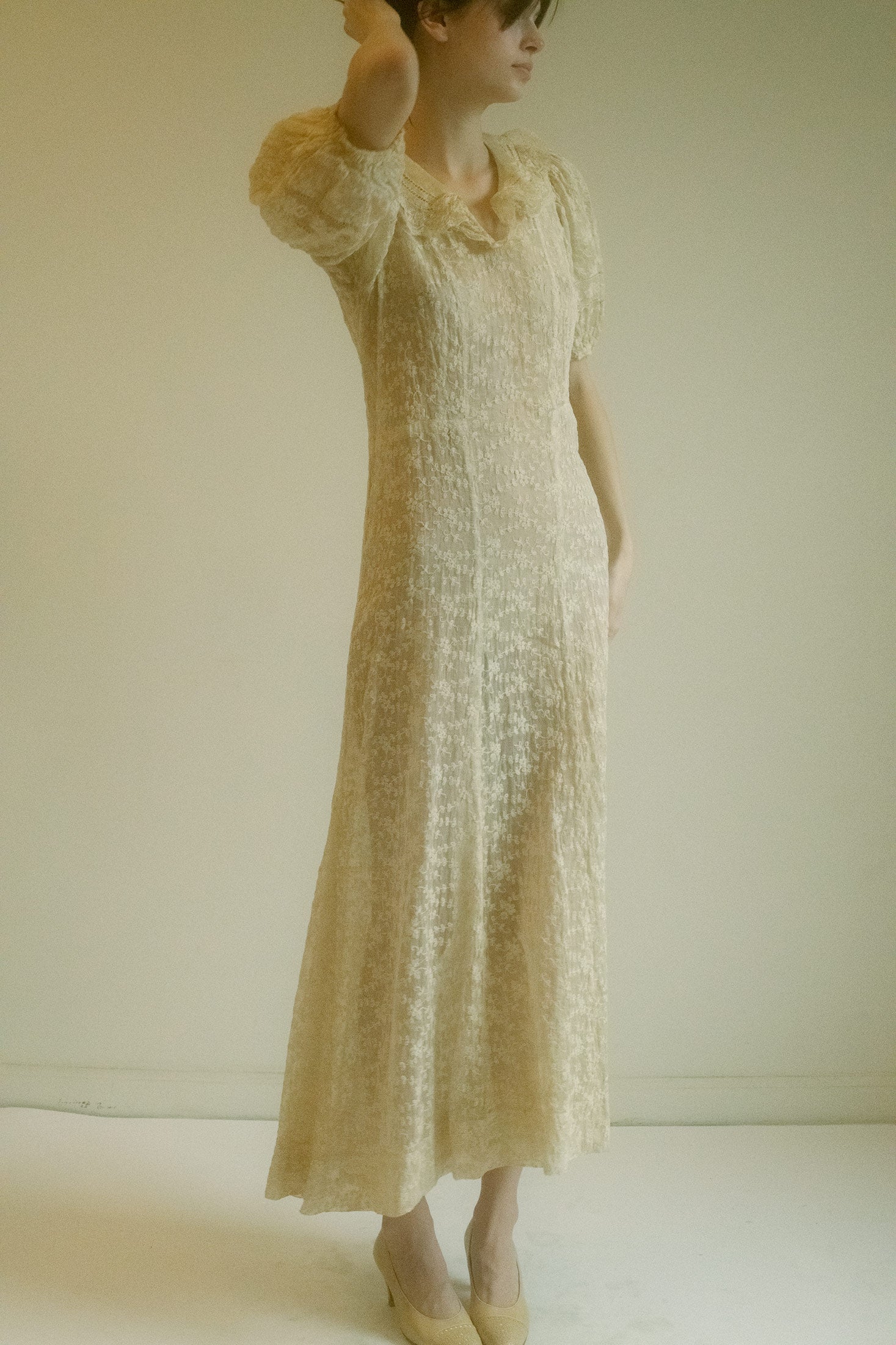 The bell sleeves flow with delicate movement, adding a dynamic elegance that enhances every gesture.