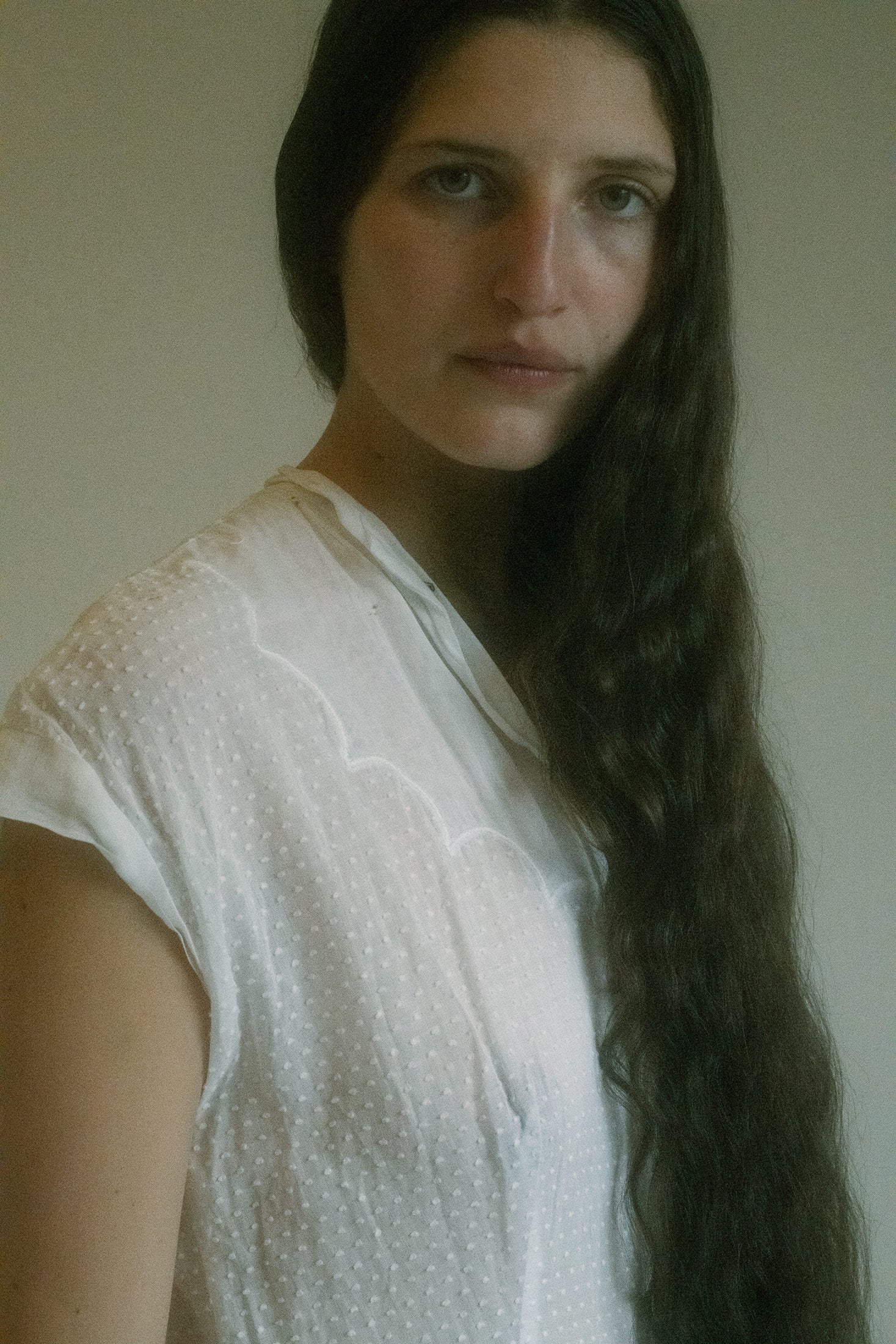 The waist is gently gathered, offering shape without insistence, and the skirt falls to mid length with an easy sway.