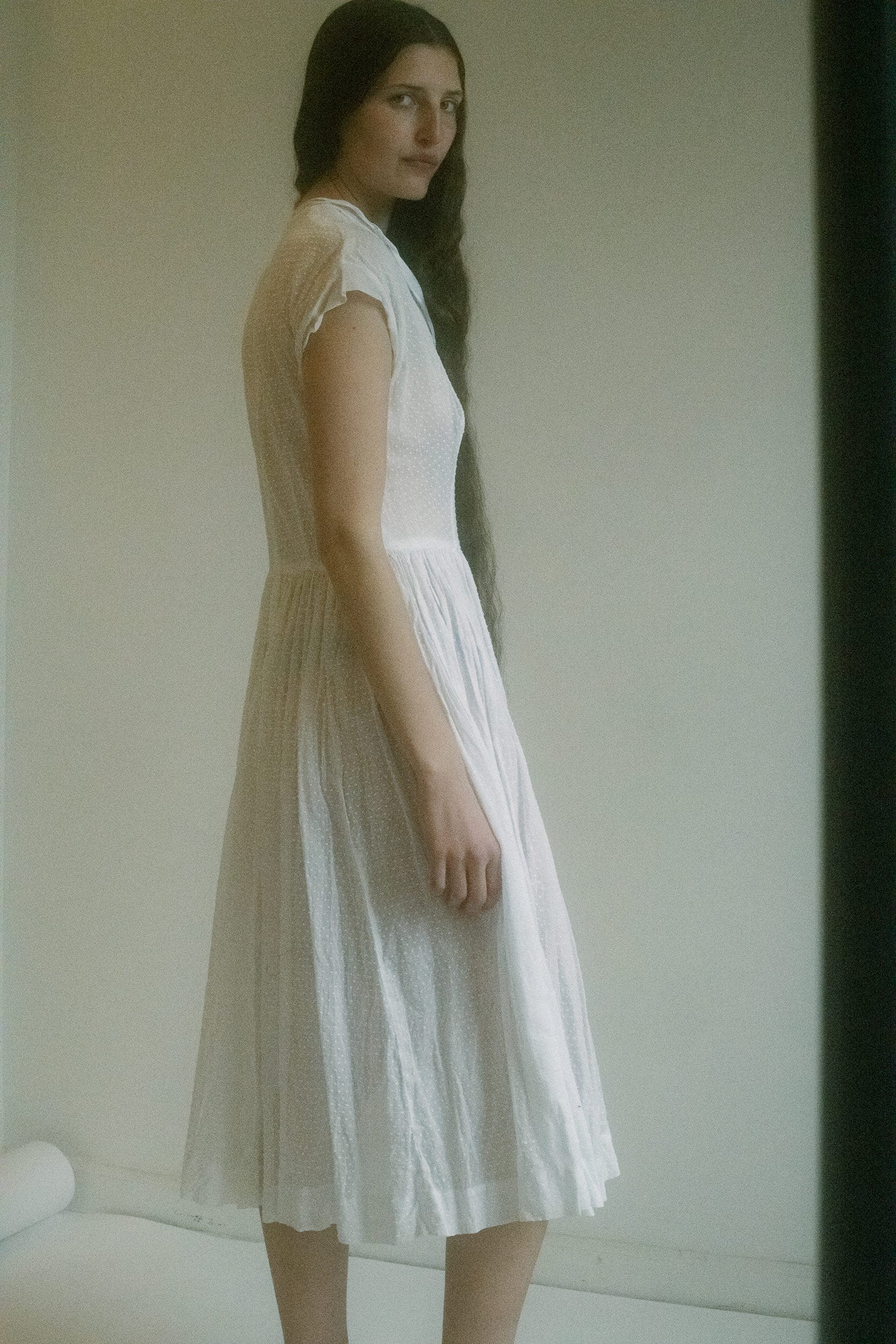 Light plays through the cotton’s subtle perforations, casting soft patterns on skin.