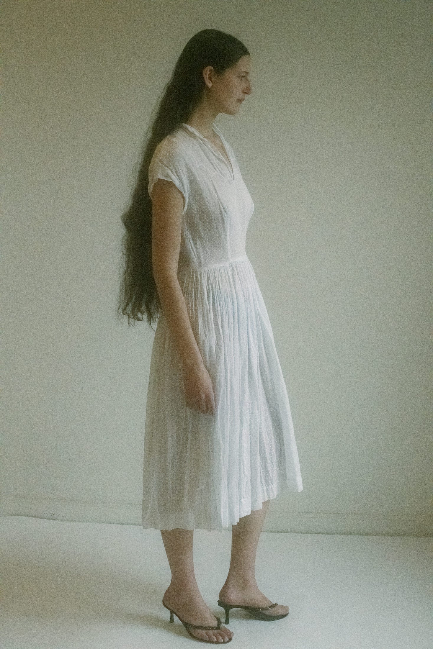 A vintage white dress that leans into suggestion more than statement.
