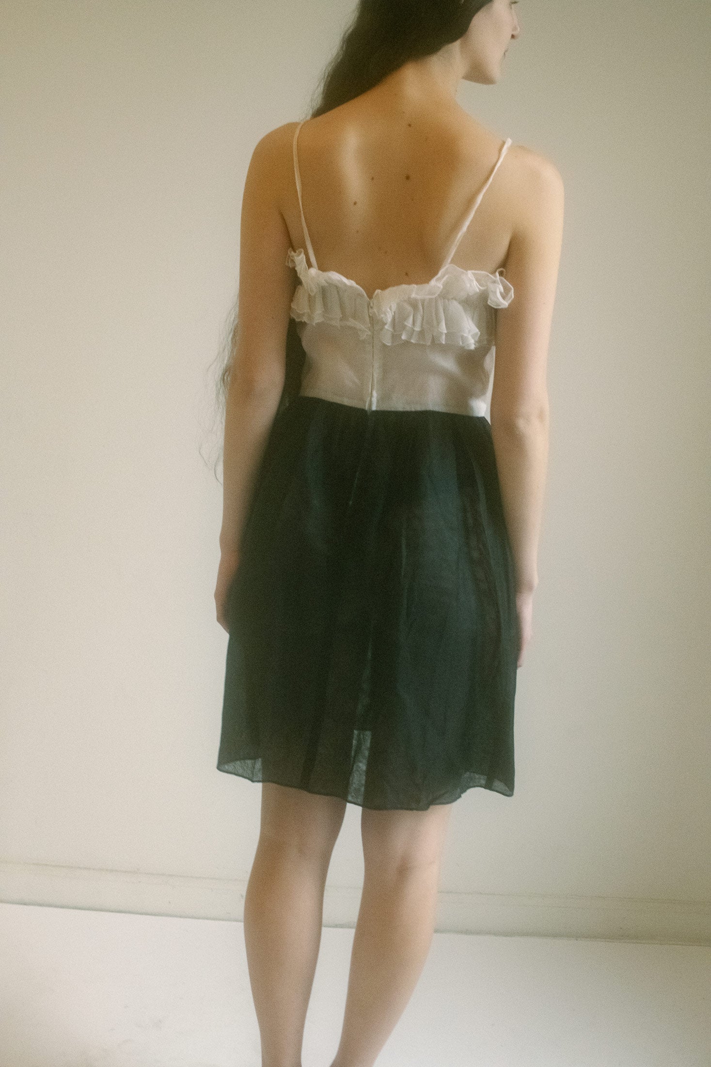 Sheer fabric cascades from top to bottom like a fleeting secret, teasing and revealing in all the right places, but never giving everything away.