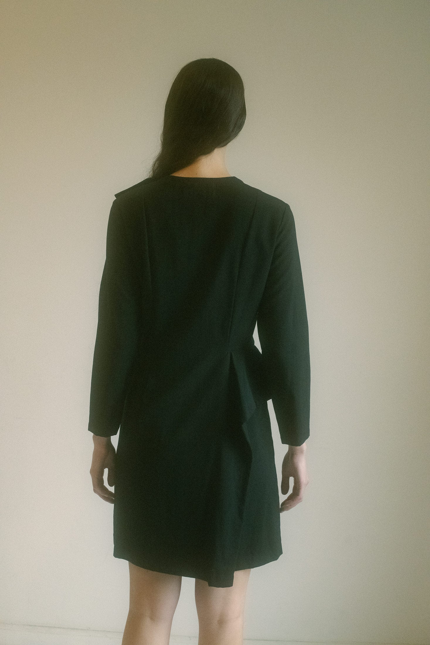 The ruffle details, artfully placed, add movement and texture, creating a sense of playful sensuality that contrasts beautifully with the dress’s refined simplicity.