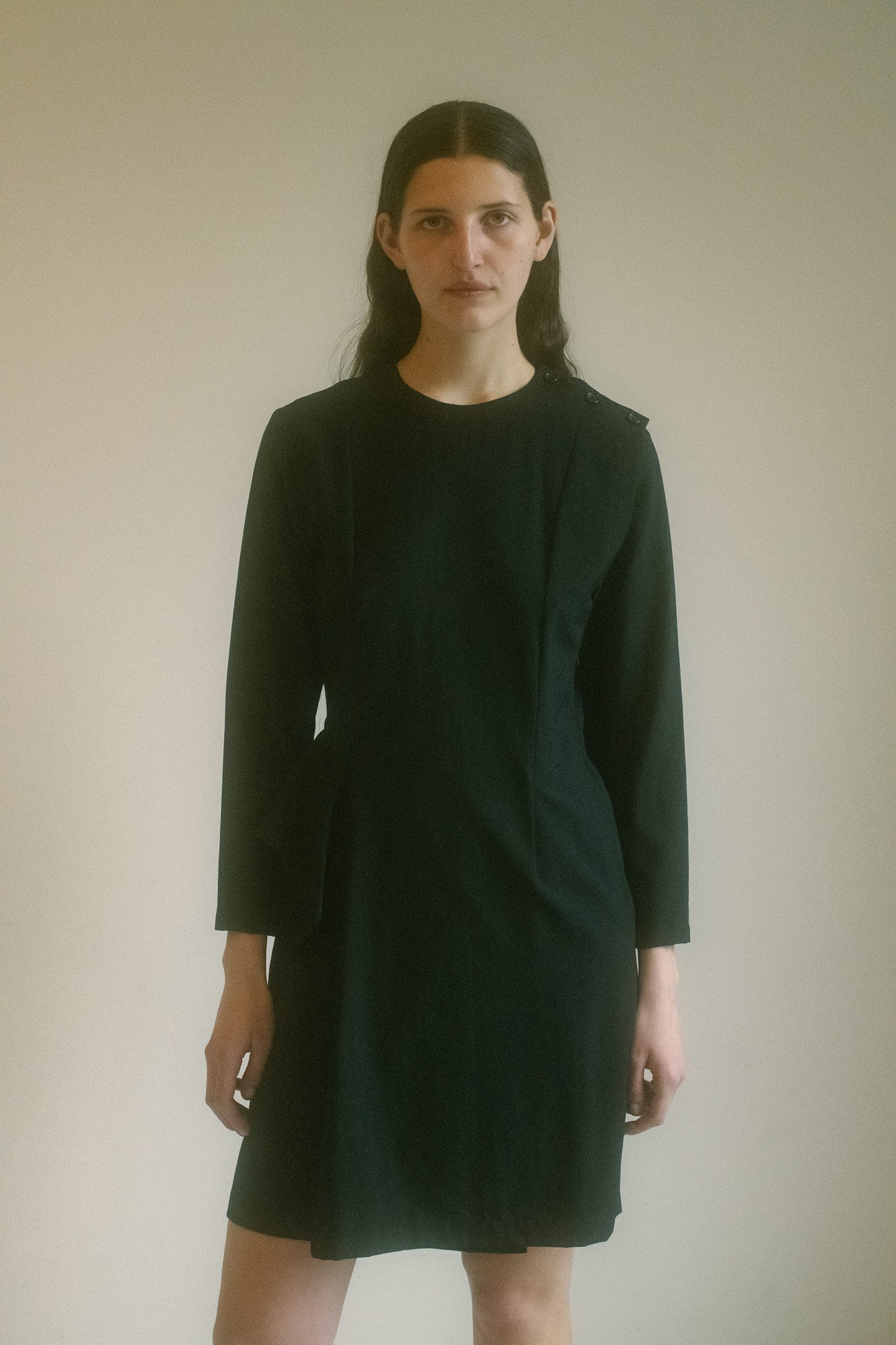 The Tricot CDG Ruffle Dress is where understated elegance meets dynamic design.