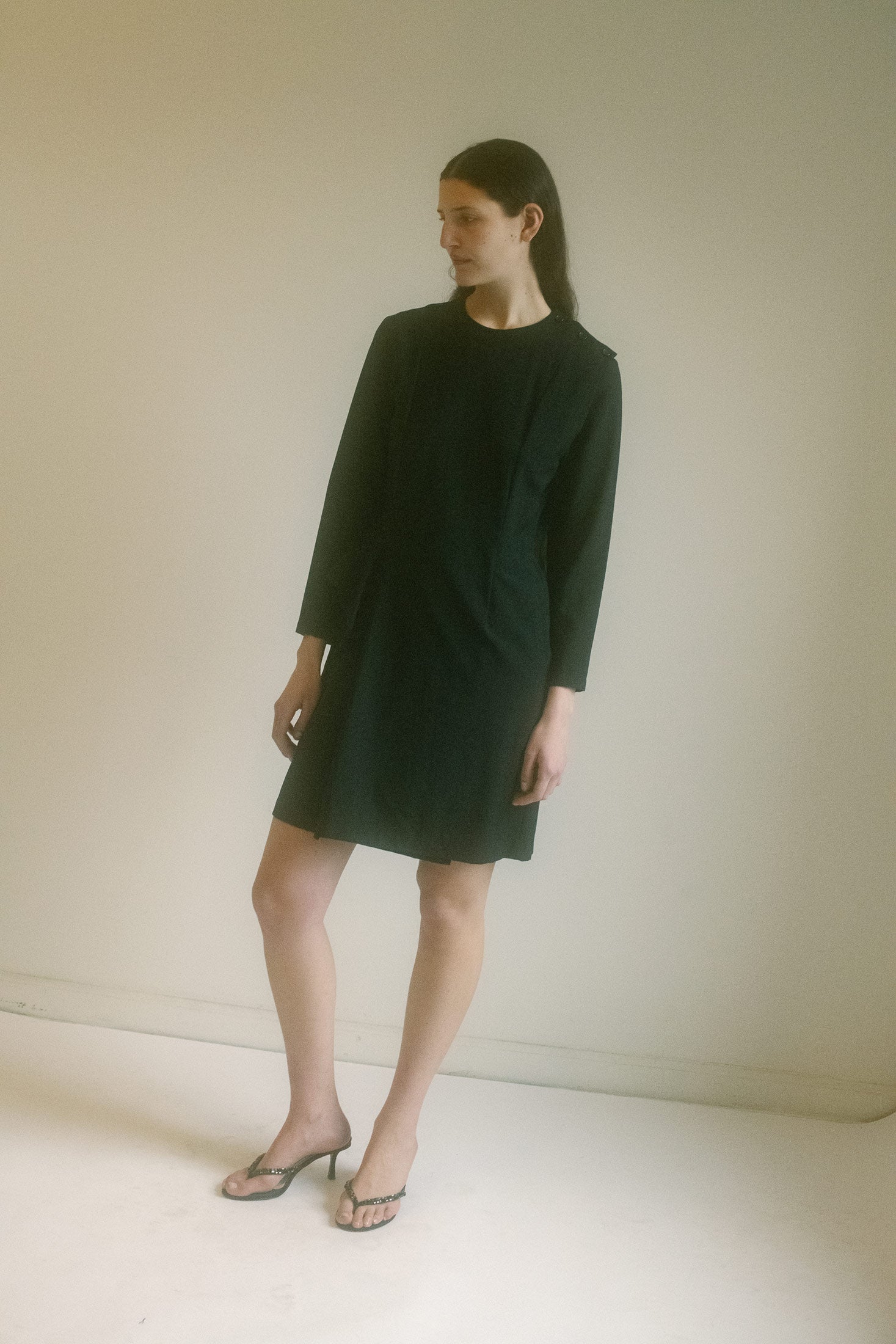 The Tricot CDG Ruffle Dress is both desirable and relatable, a timeless piece that belongs in the city but holds the grace of a classic.