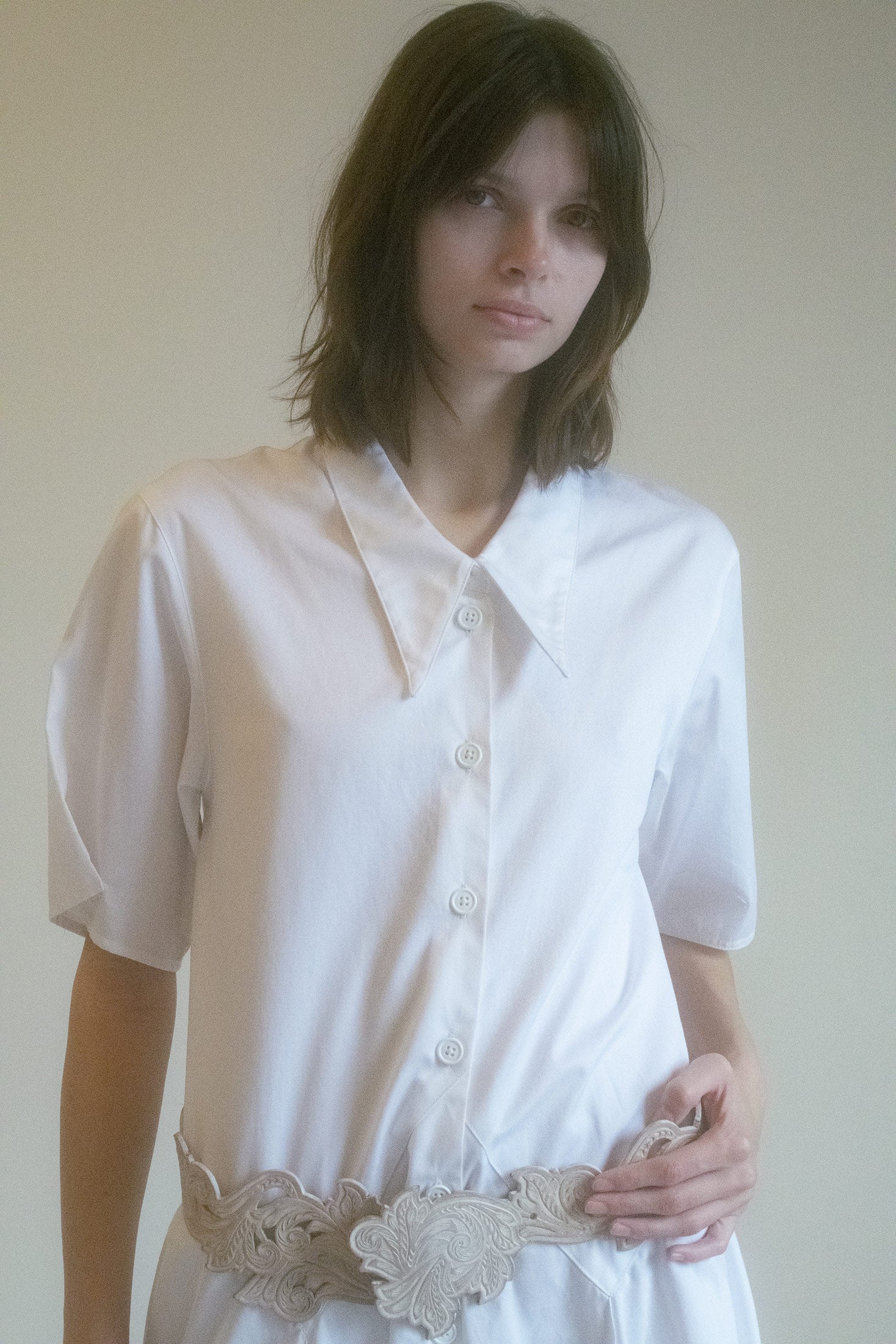 The front button details offer a touch of intrigue, allowing you to adjust and shape the dress to your perfect fit.