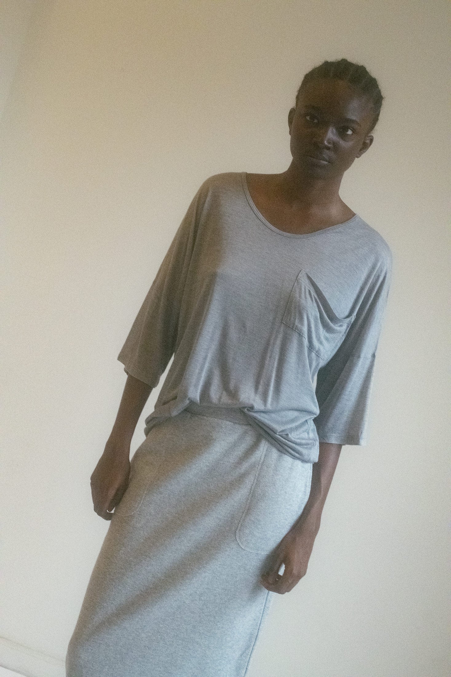 The fabric, thin and soft as a sigh, drapes over the body with a semi-sheer transparency that invites curiosity, while maintaining an air of mystery.