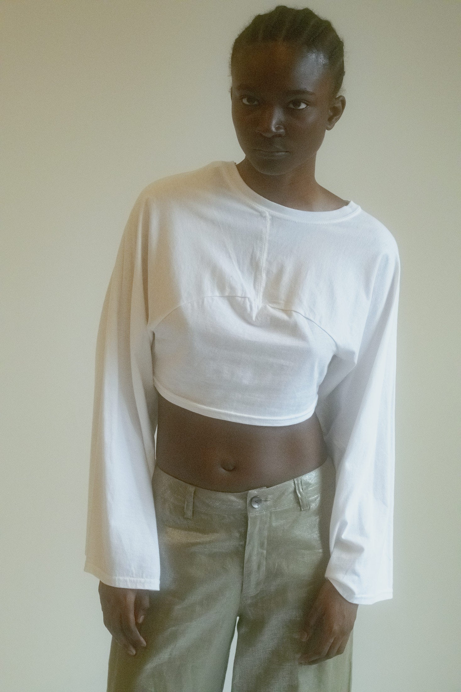 The Reworked Long Sleeve Crop Top is a modern reimagining of the classic white T-shirt, with an effortlessly chic twist.