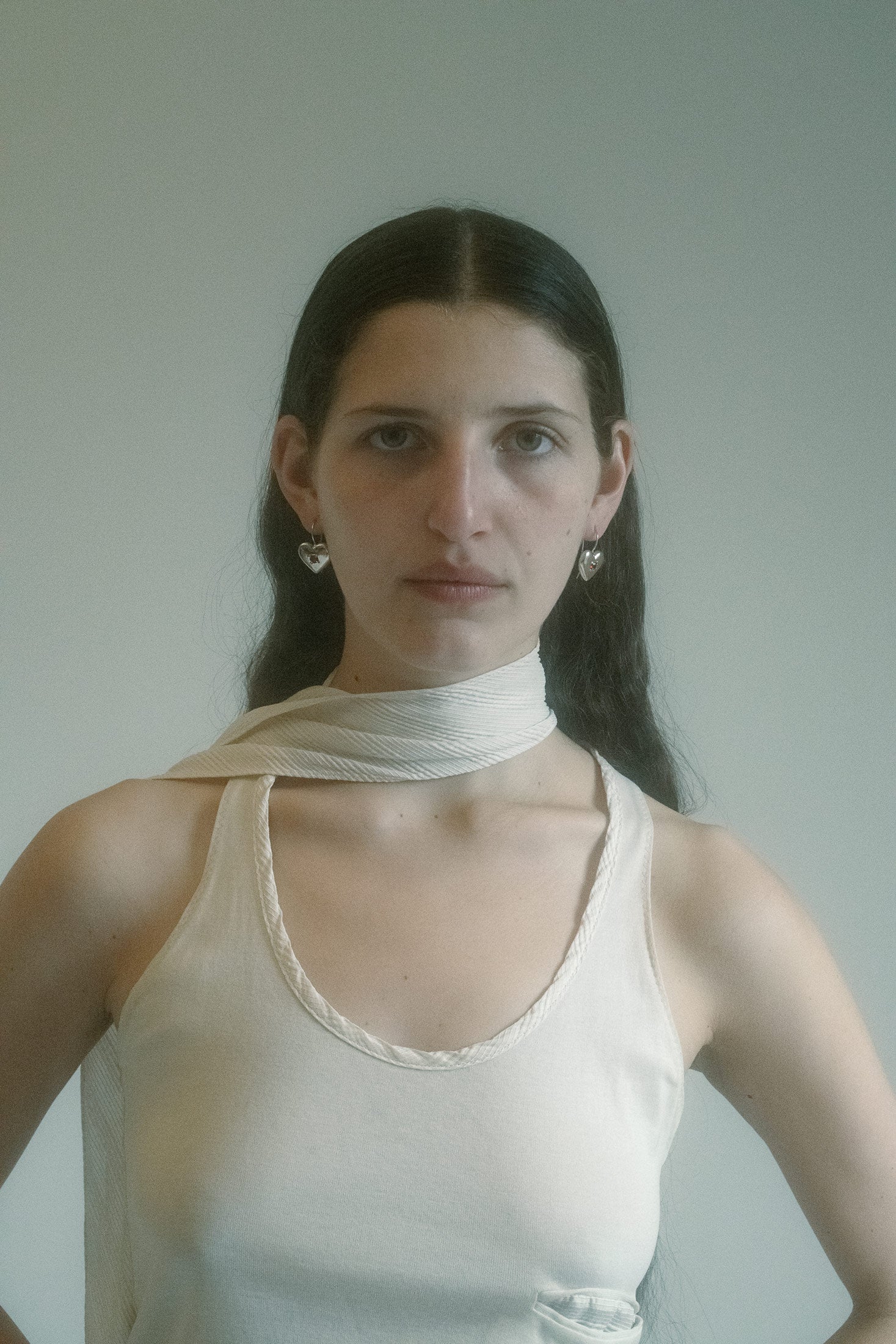 At the base: a glittered graphic charm, a silver-tone face that winks with theatrical intent.