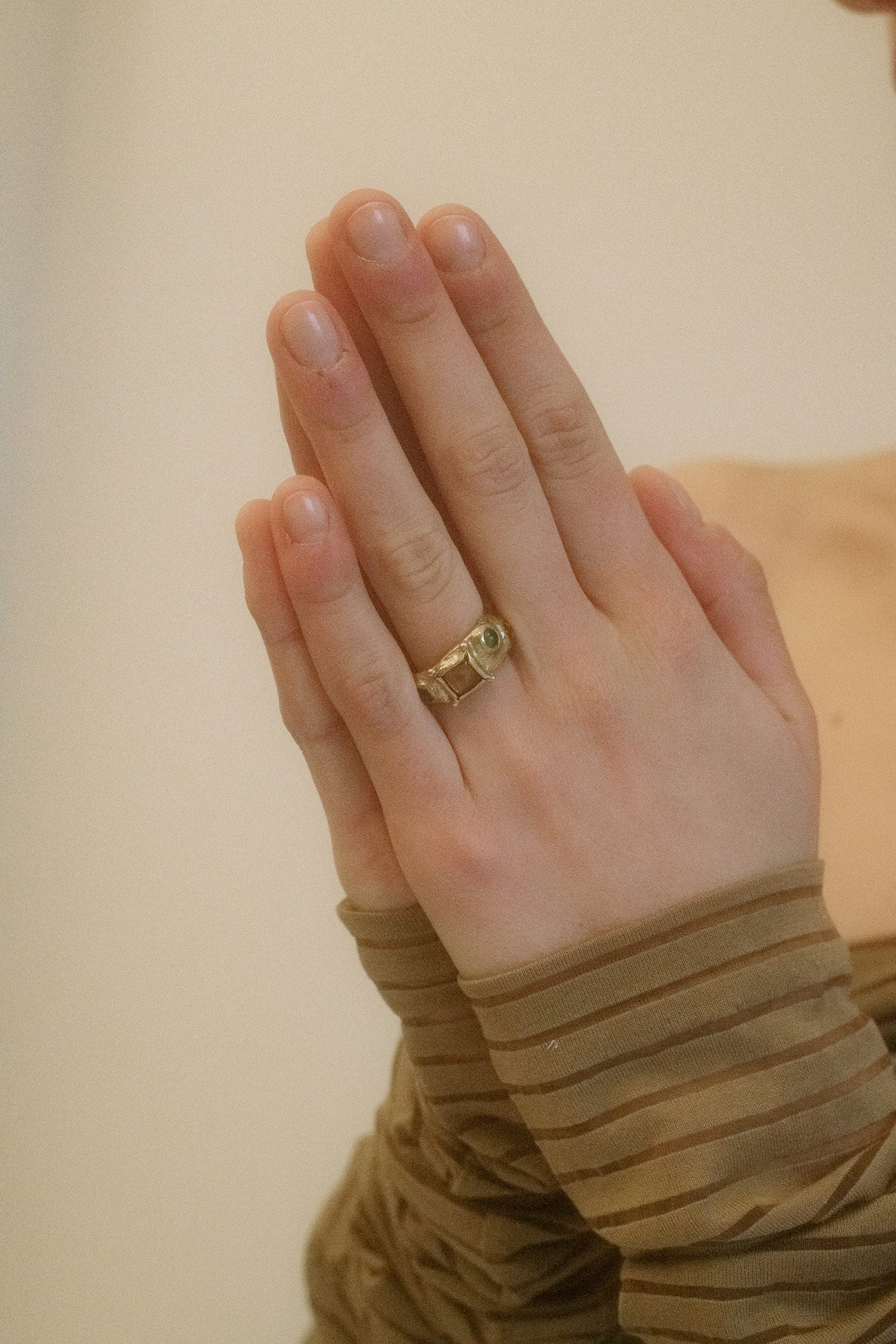 Inset glass stones catch the light at the face, adding a touch of mystique to its already captivating silhouette. Made in Los Angeles, this ring speaks to the bold and the elegant alike.