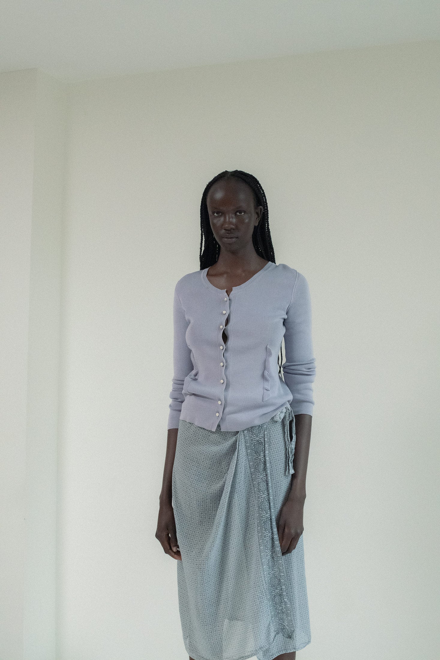 The Sonia Rykiel Pearl Knit Cardigan, a soft lilac hue, hugged her form with subtle elegance.