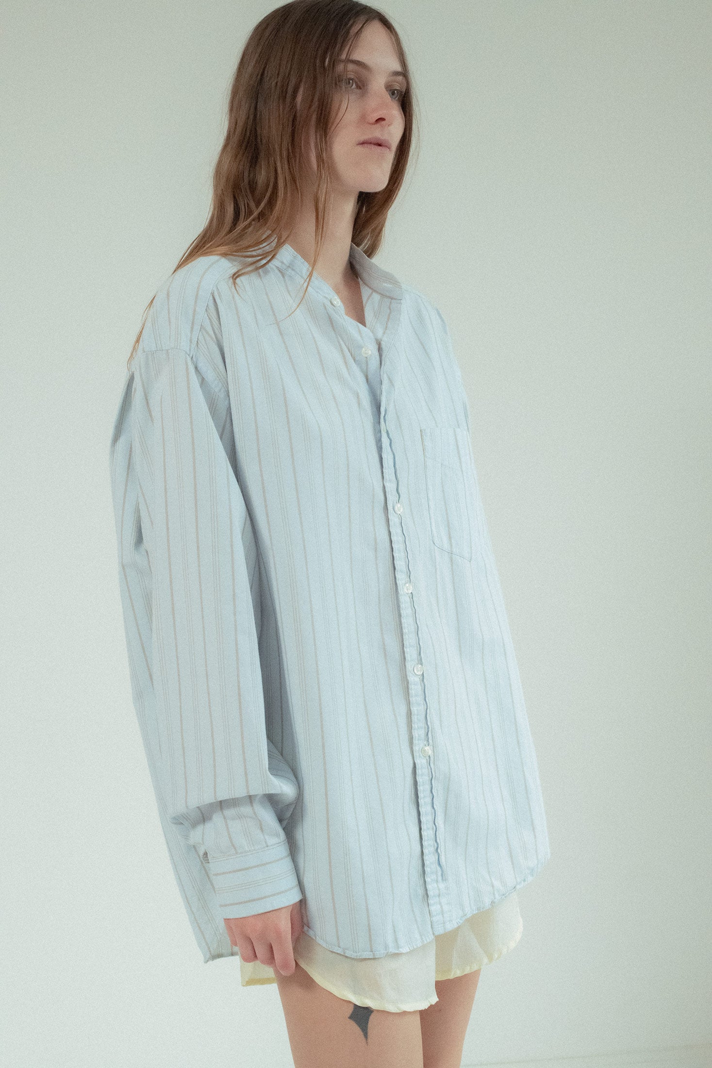 With a sleek mandarin collar and delicate stripe detail, this classic shirting piece redefines versatility.