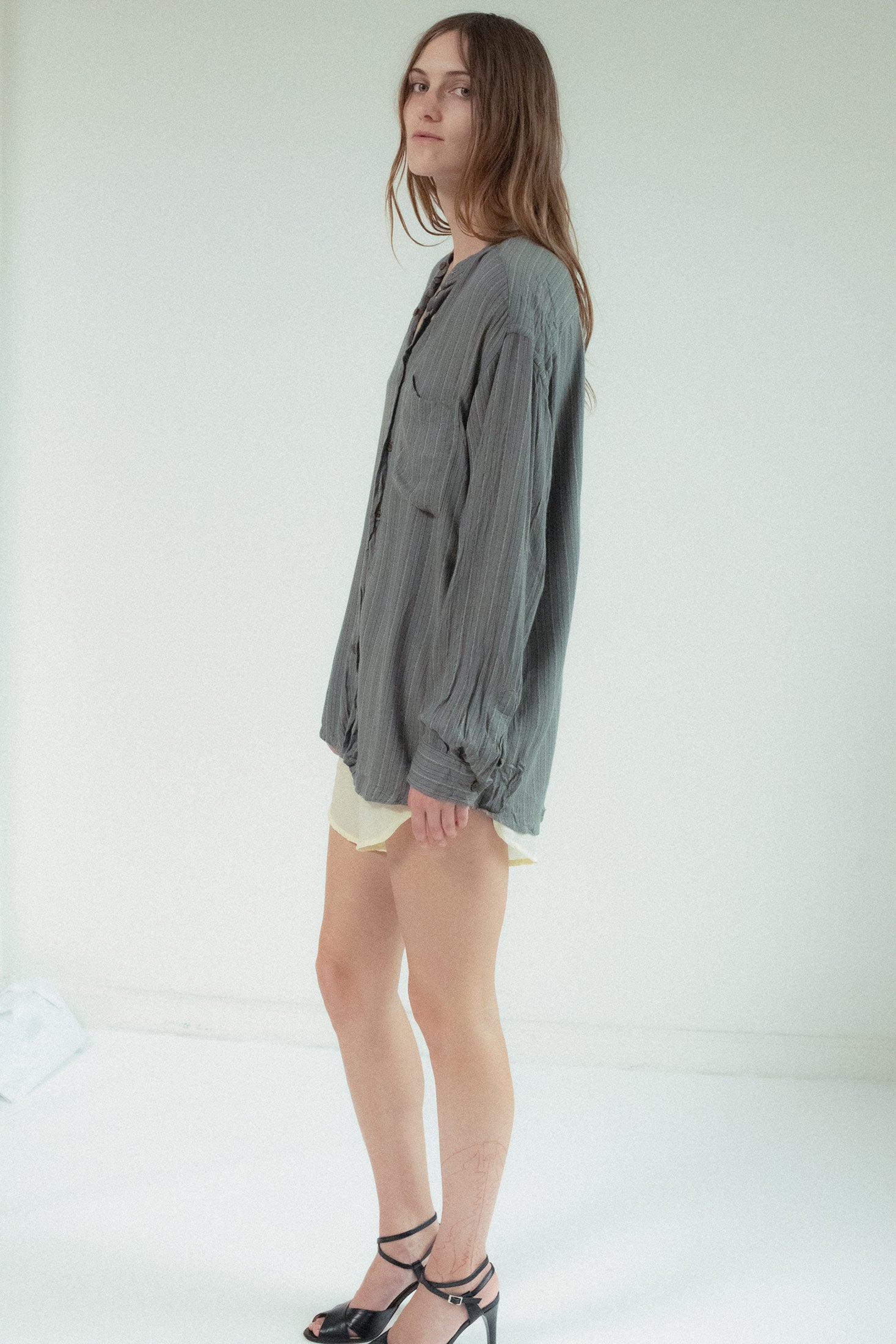 Long sleeves and a clean button closure complete the look, allowing the fabric’s natural flow to do the talking.