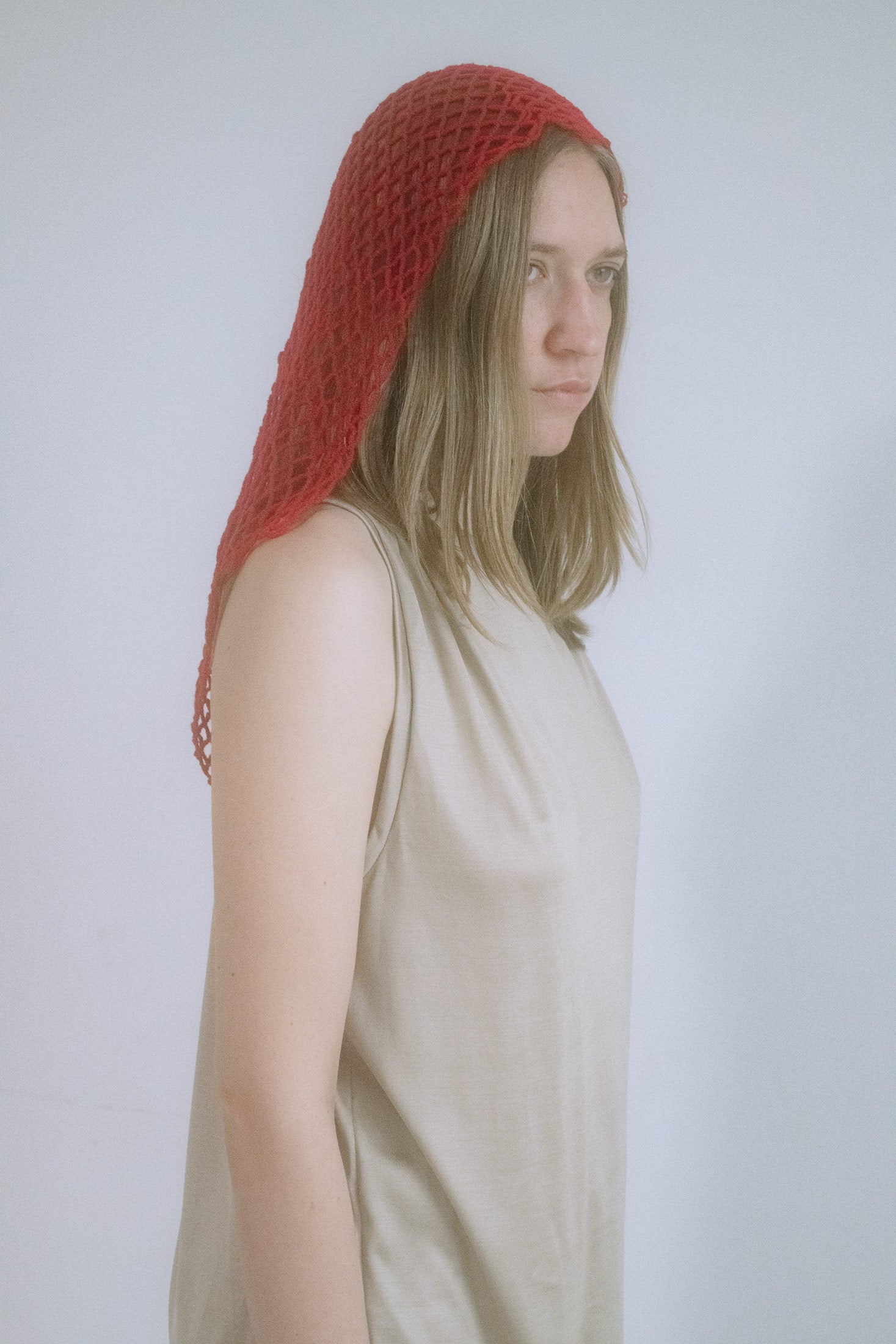 A head-turner in every sense, this knitted net hood from Judy Turner wraps the head like a whispered secret.