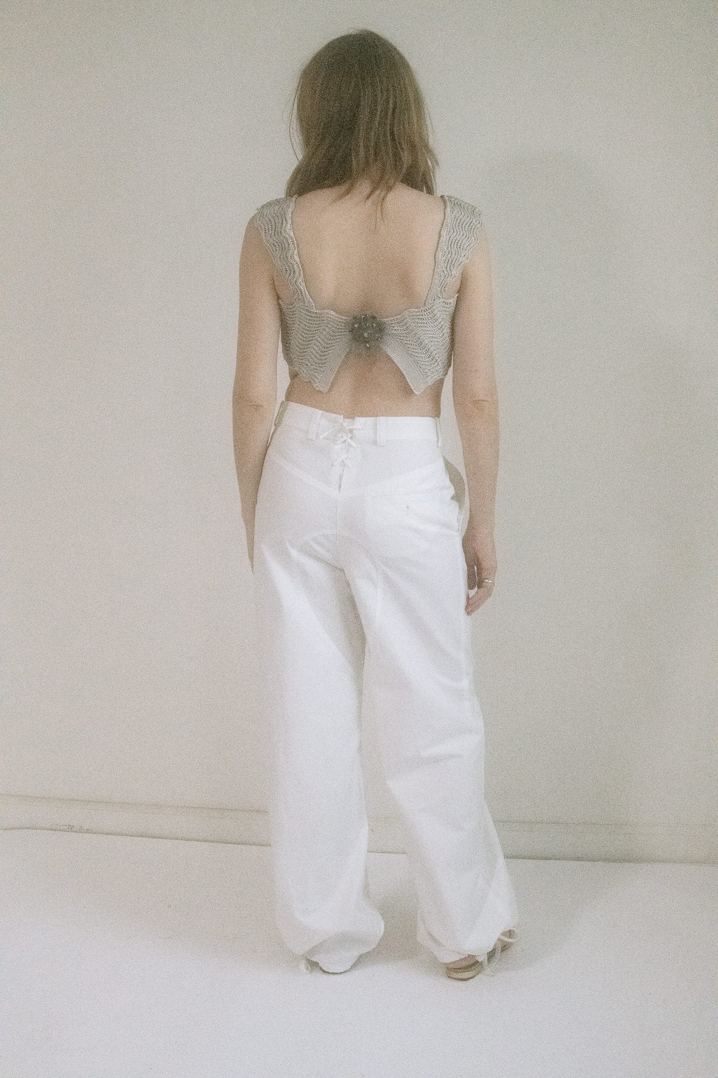 Cropped just enough, with scalloped edges tracing the hem and delicate straps, like lace frozen mid-melt.