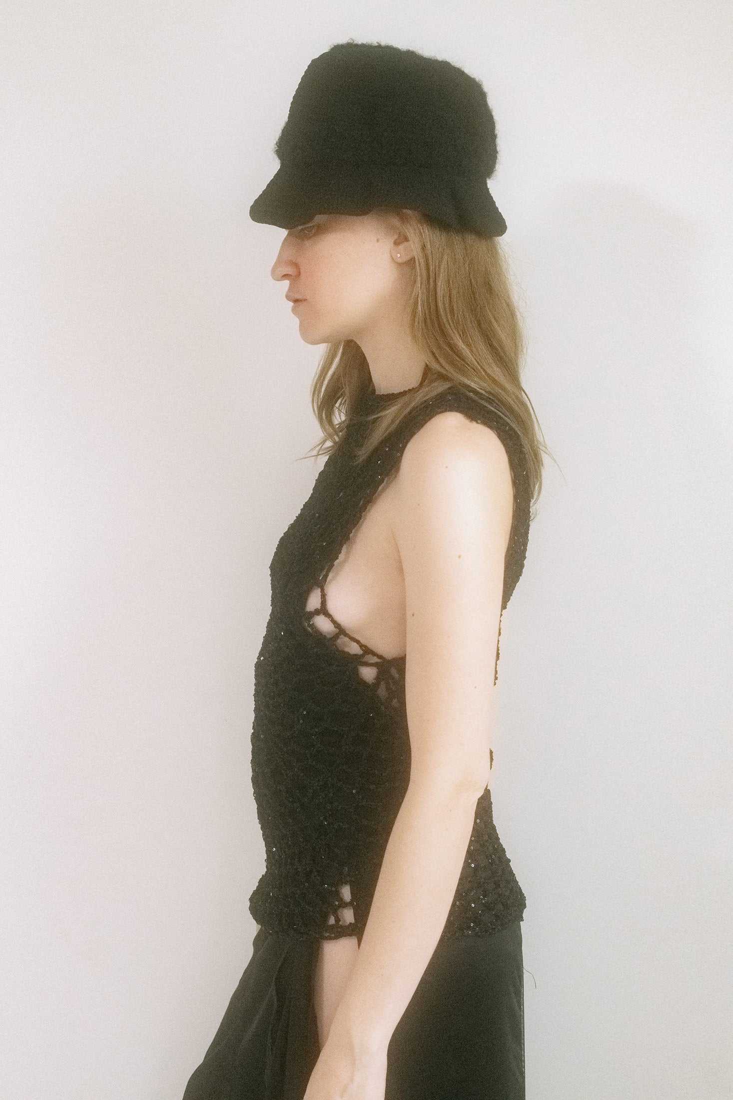 From the hands of Judy Turner comes a knit hat that tilts toward the surreal — crafted in New York with a small, sculpted brim and exaggerated volume that peaks into a quiet, fin-like crest.