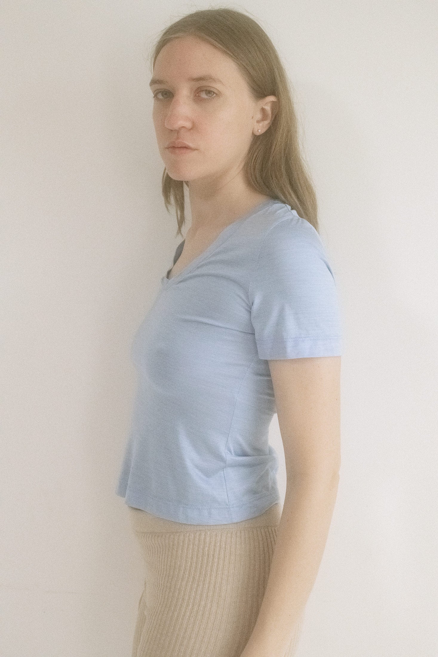 Crafted from cotton jersey with a subtle sheen that catches the light just right, its relaxed, slightly cropped fit drapes like a whispered promise.