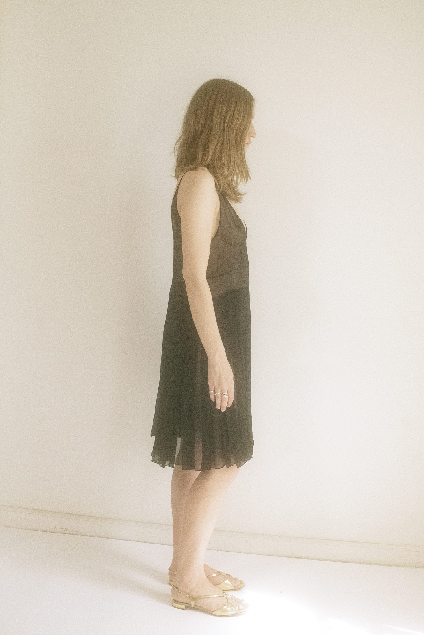 Draped in a deep black hue, it’s the kind of dress that lingers in the shadows, ready to unveil a story.