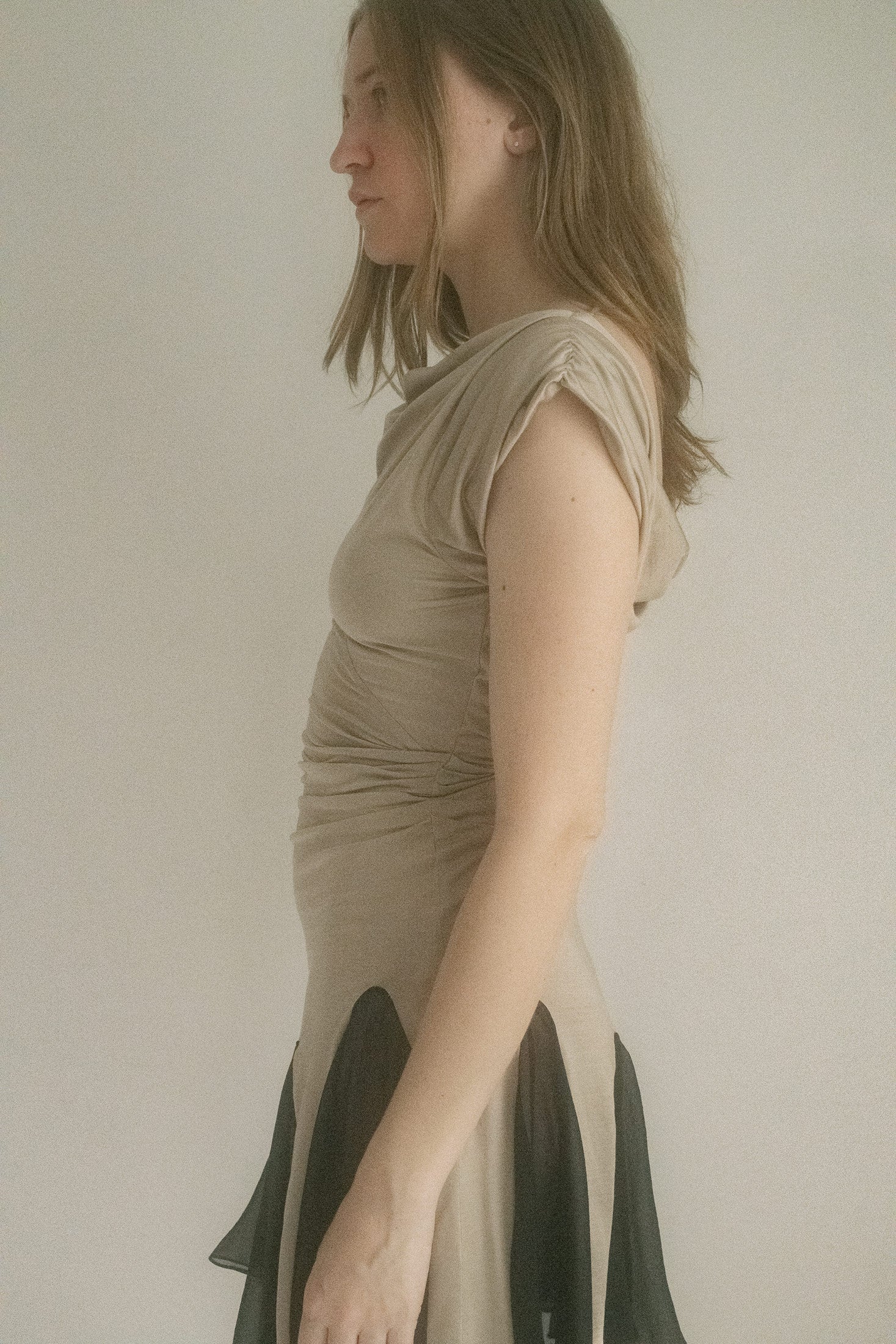 Ivory with black accents, the cap sleeves barely graze the shoulder, while a plunging low back leaves just enough to the imagination.