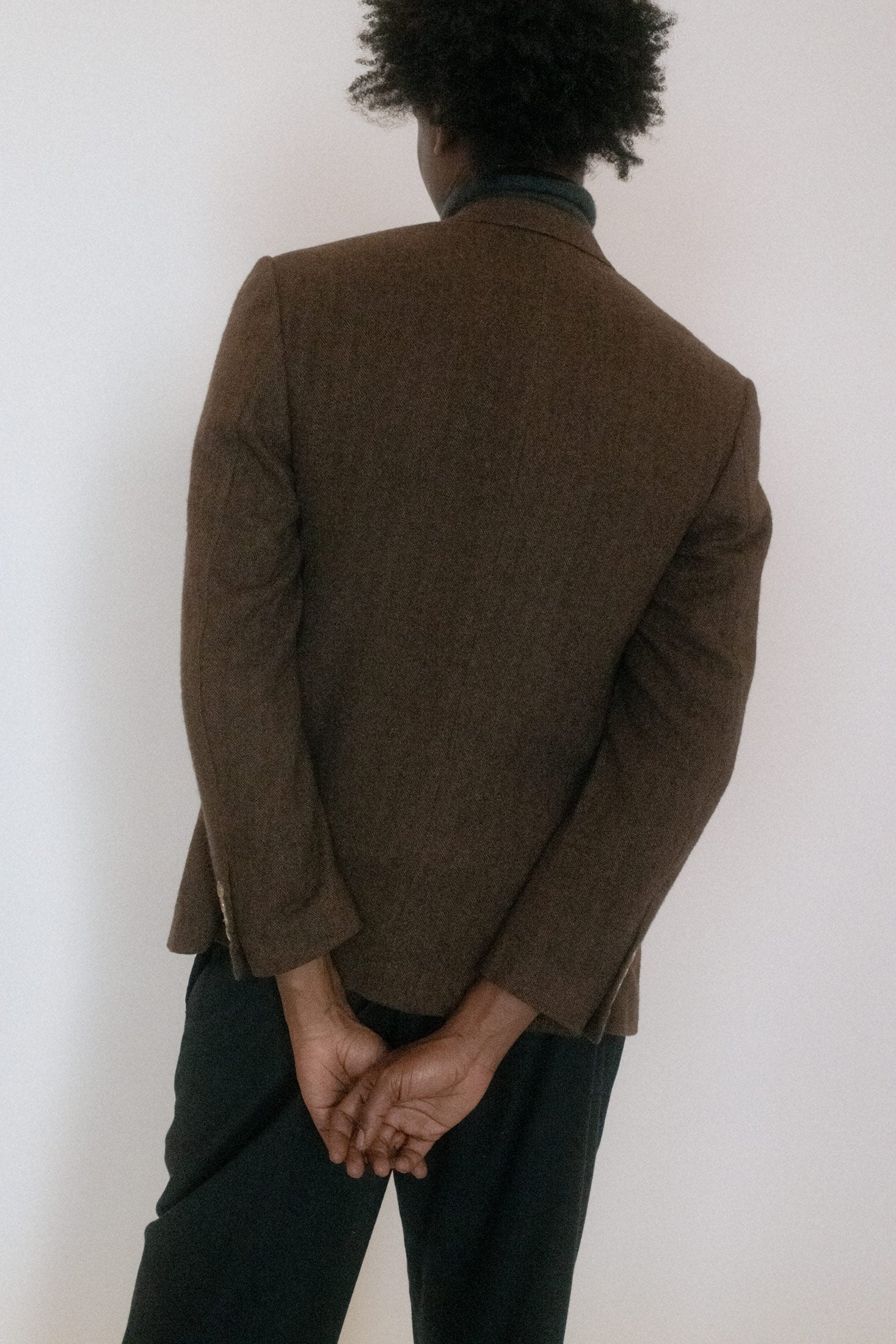 The warm brown hue feels grounded, though it catches your attention like a knowing glance across a smoky bar.