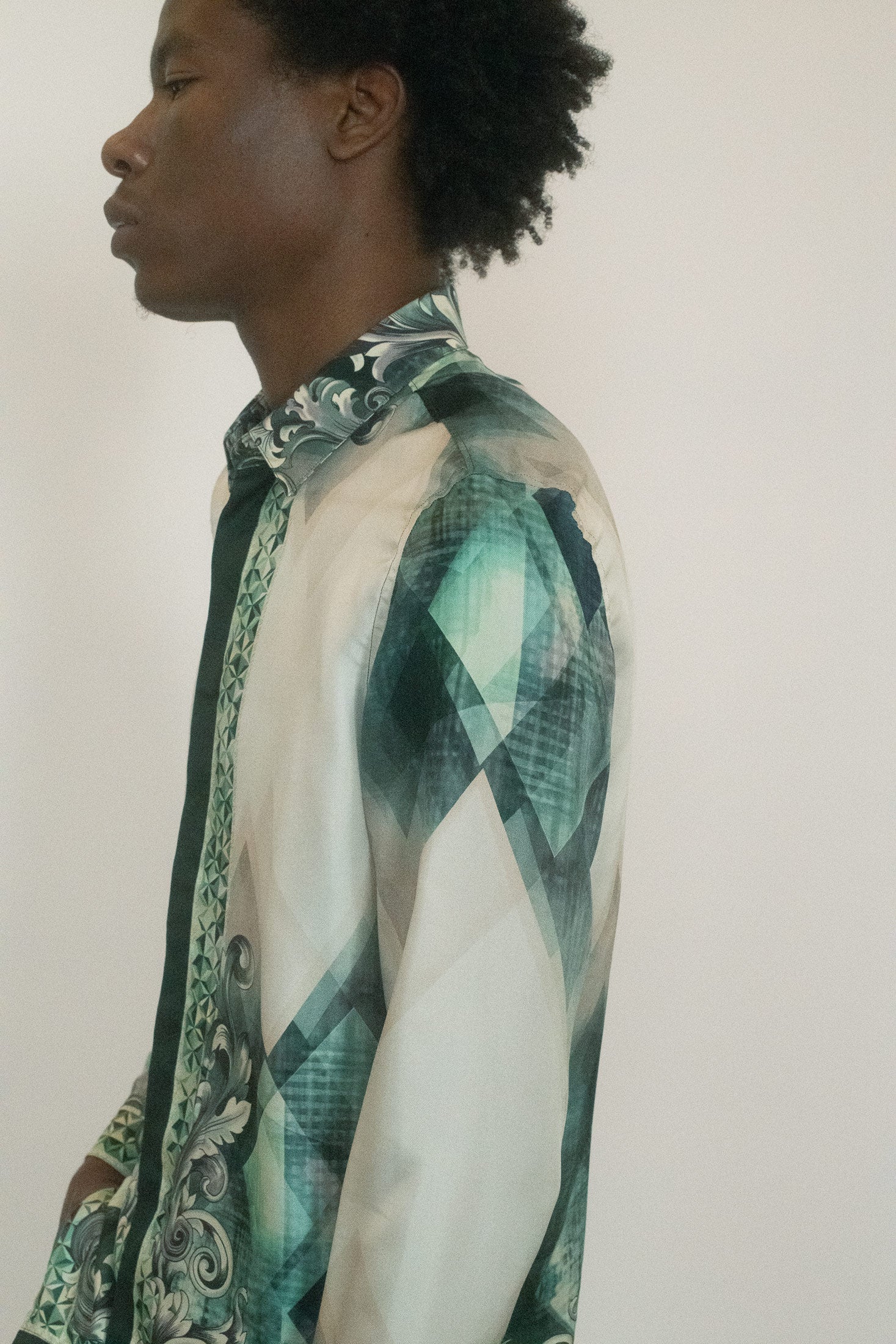The classic collar anchors it in menswear tradition, but the patterned silk refuses restraint.