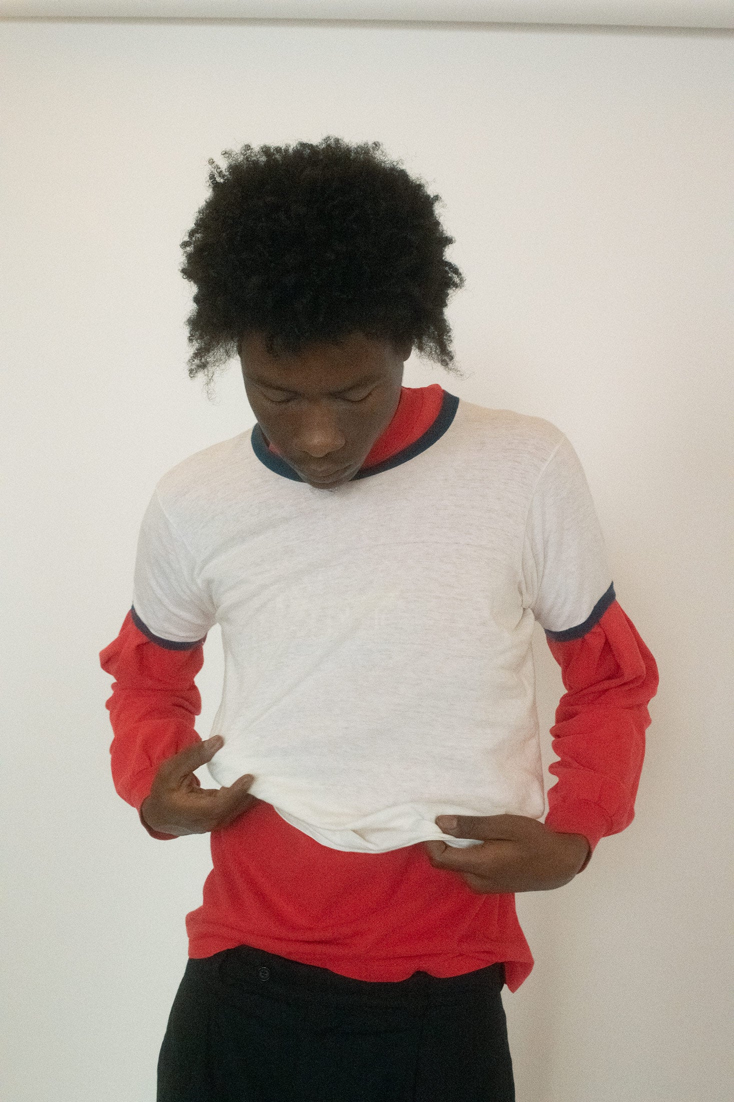 A short-sleeved ringer tee layered over a long-sleeve red top, sold together as a pair.