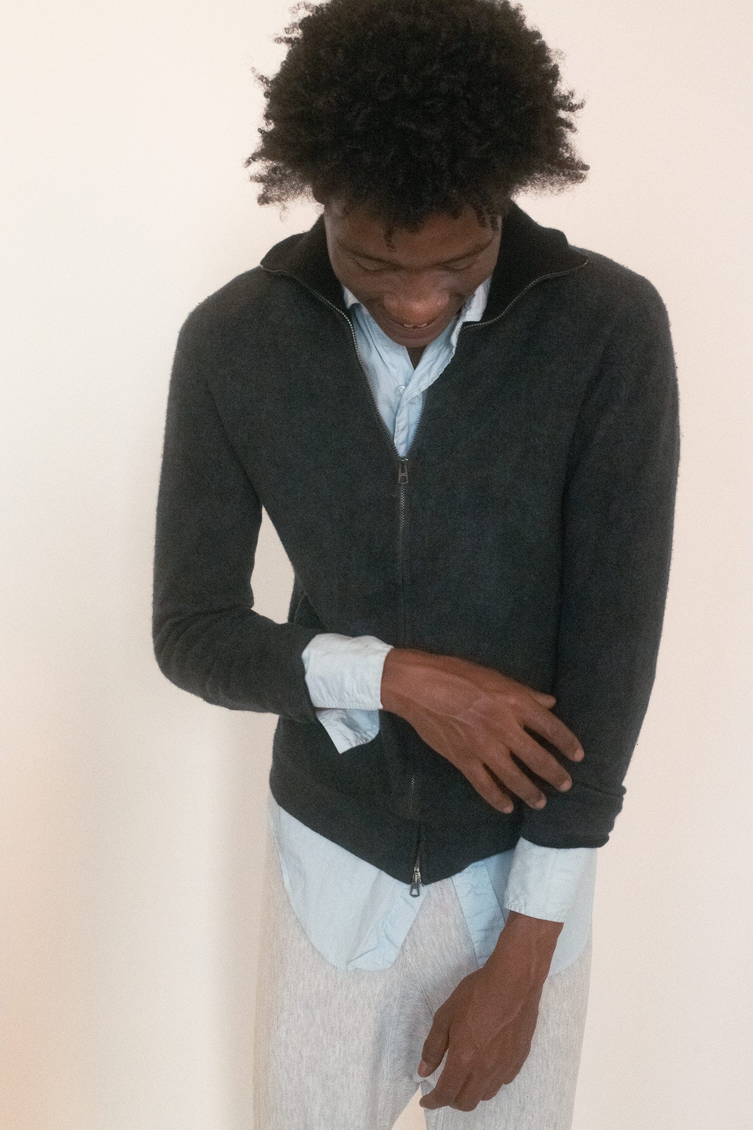 The high neck draws the line upward, deliberate and severe, while the double-pull zipper invites a game of exposure.
