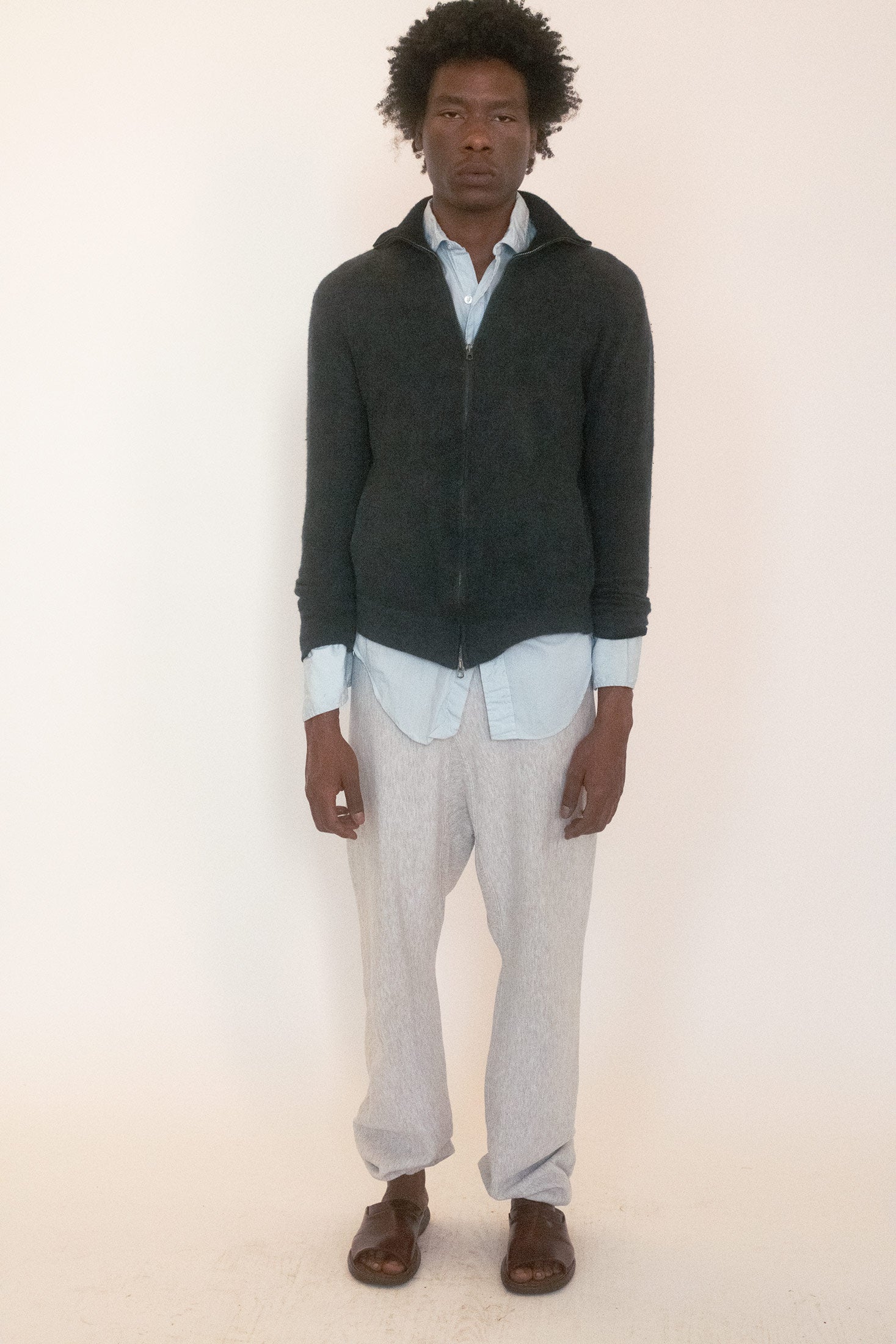 A vintage zip up sweater in deep charcoal, the kind that cloaks itself in understatement until you notice the details.