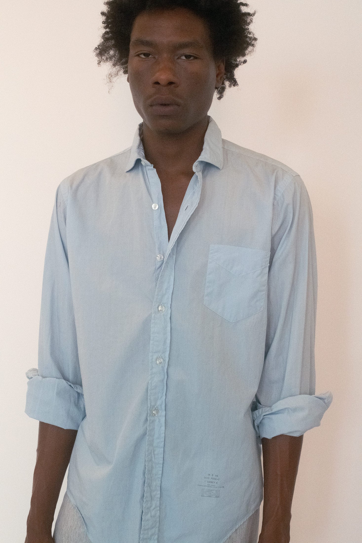 The classic collared cut and button front ground it in tradition, but the fabric’s patina tells a story.