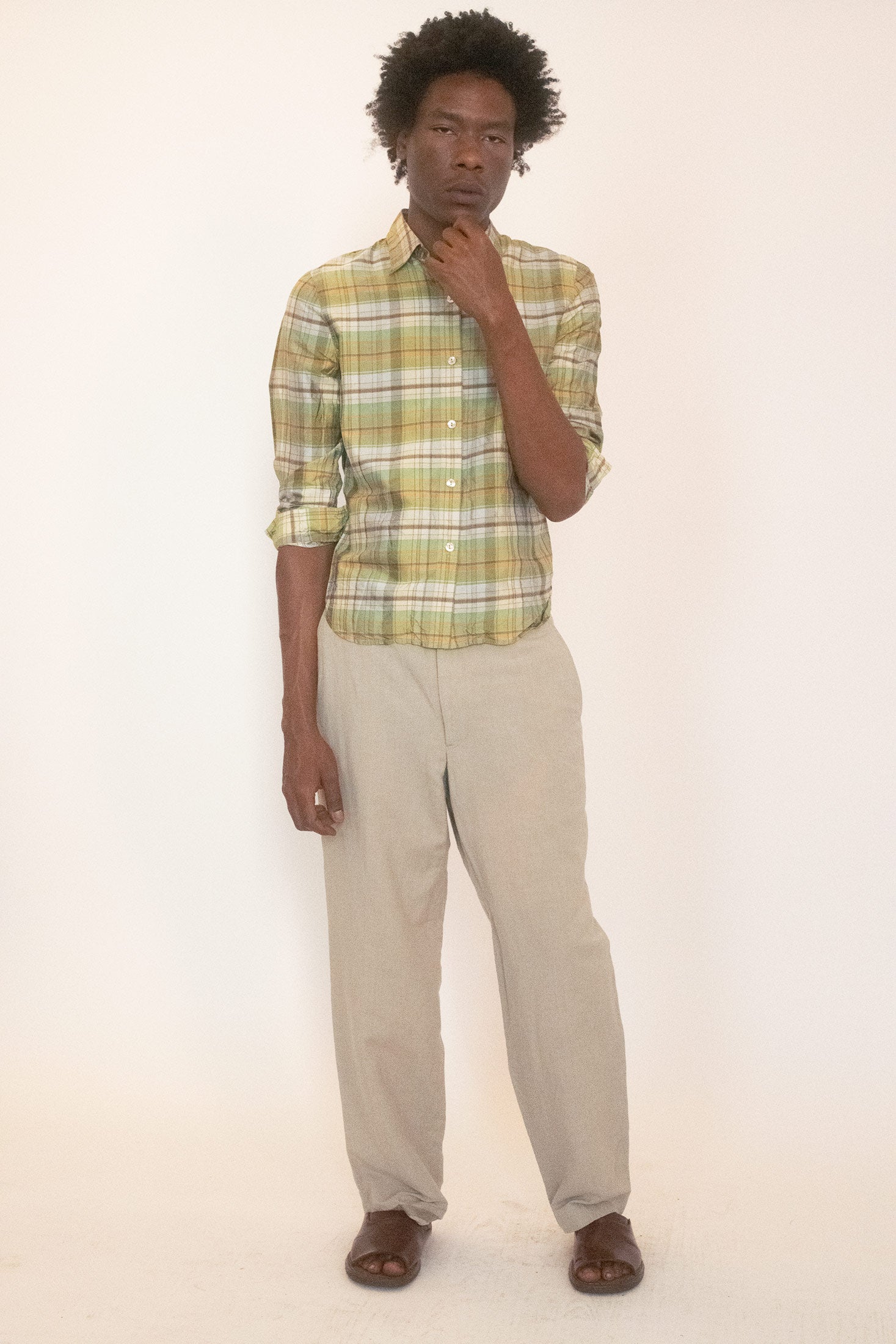 Cut in silk with a green plaid, it carries the softness of luxury against the edge of pattern.