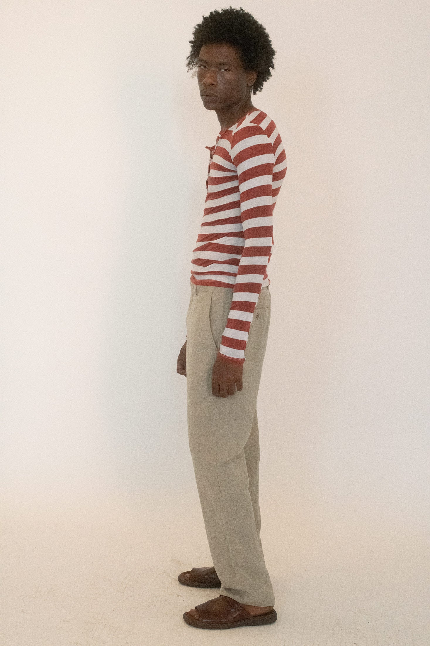 The stripes do all the talking: copper orange bands pulsing against stark white, a contrast that feels at once playful and severe.