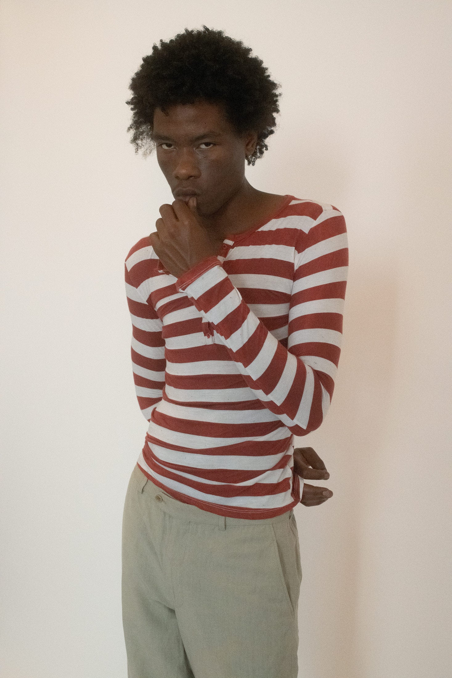 Cut in a unisex long sleeve silhouette, it buttons down the front with casual ease.