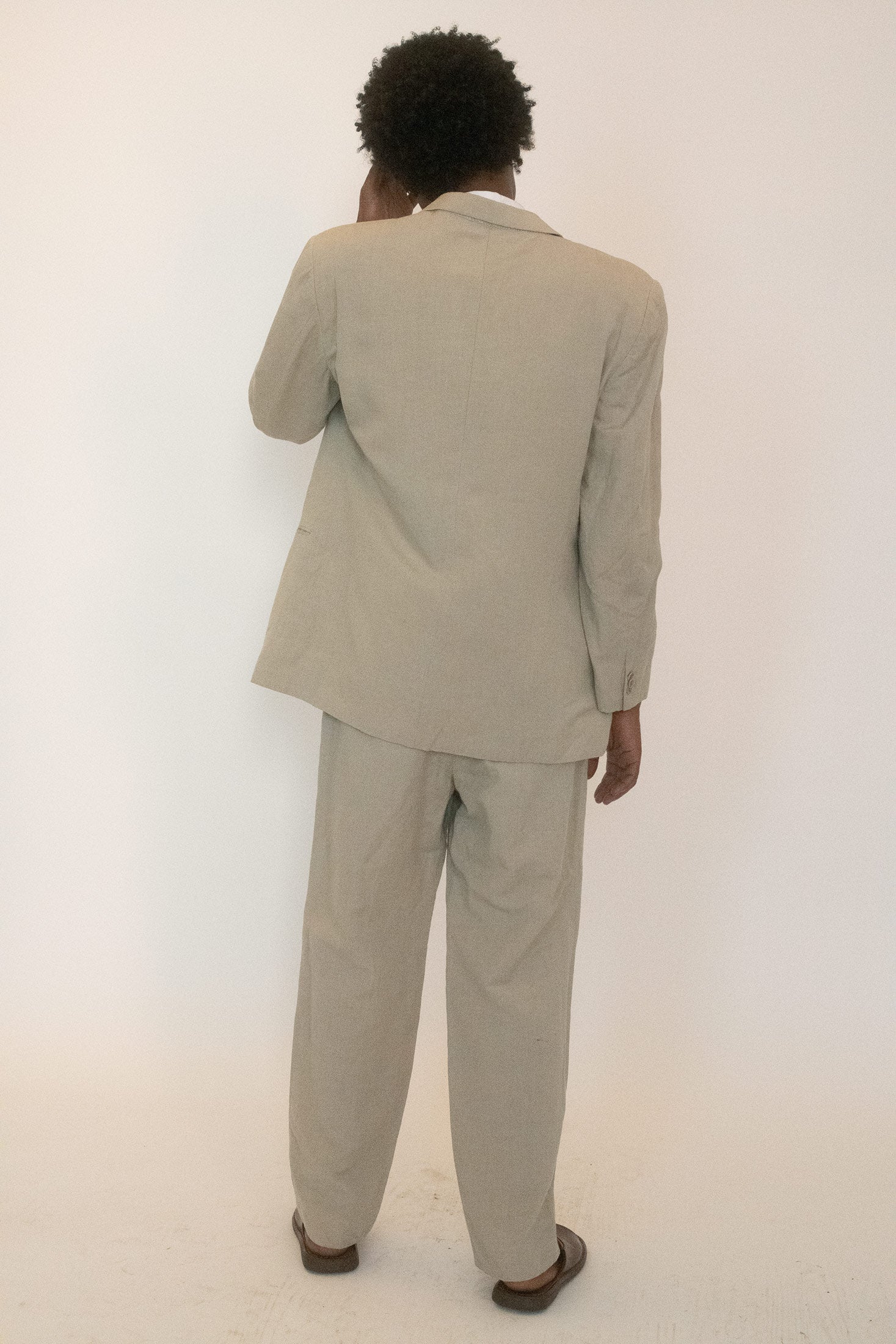 A classic cut reimagined as unisex, sourced from The Society Archive, holding onto Armani’s language of quiet power.