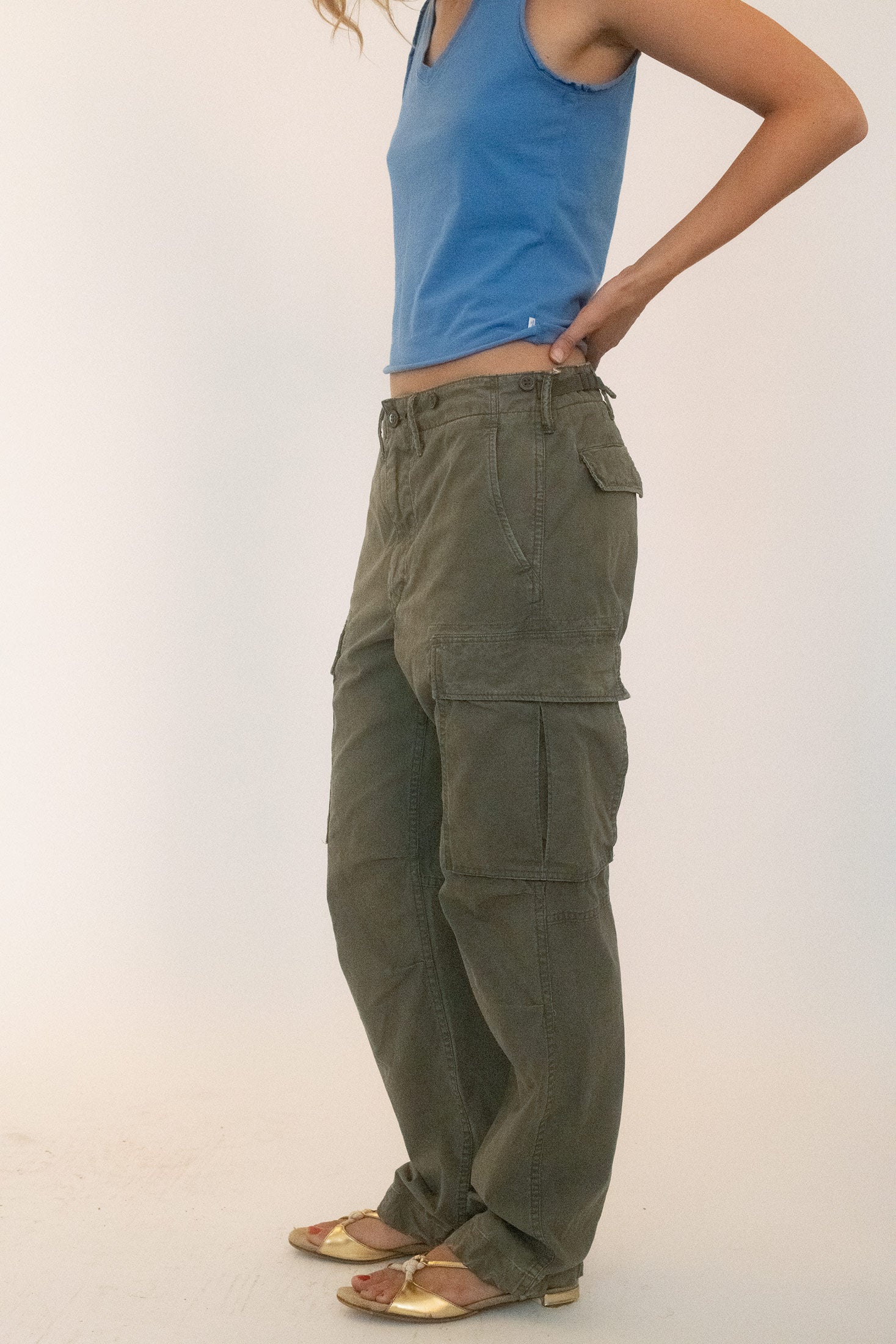 The single button closure and zip fly keep things sharp, while diagonal front pockets angle across the hips like intentional slashes.