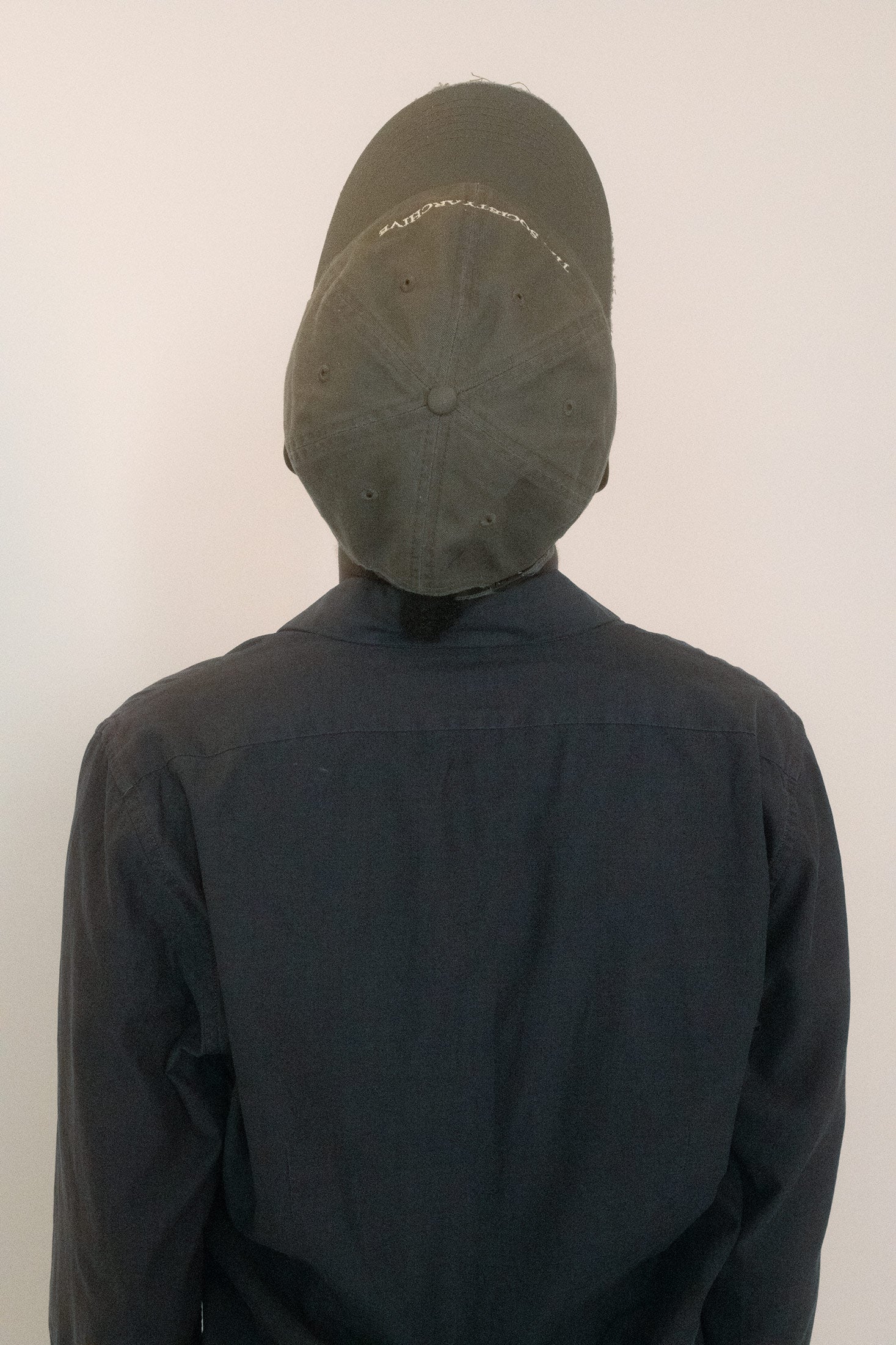 At the back, an adjustable strap keeps the fit easy, while the front is marked with custom embroidery.