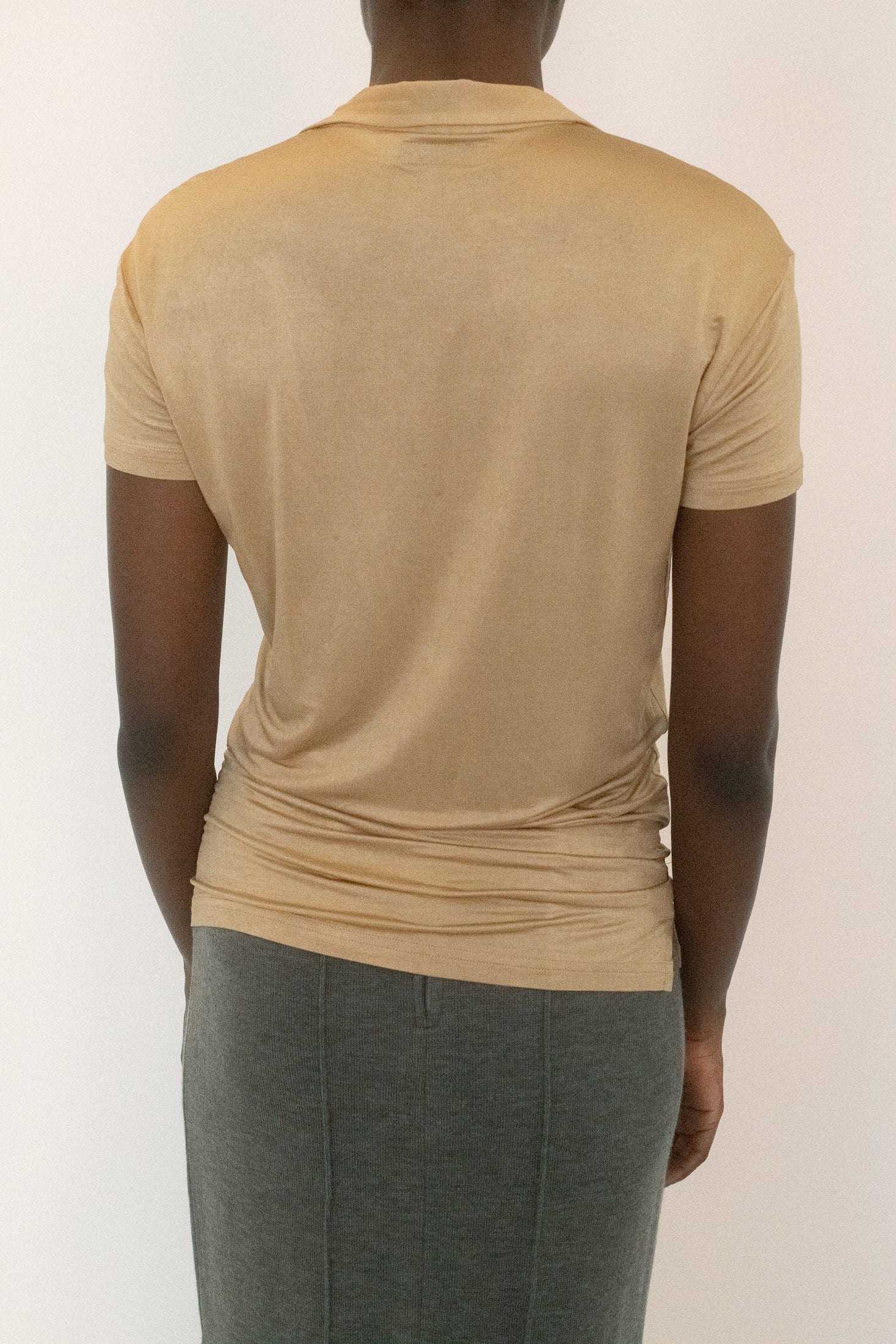 Across the chest, a tonal logo sits almost invisible, the kind of branding that feels less like a signature and more like a secret.