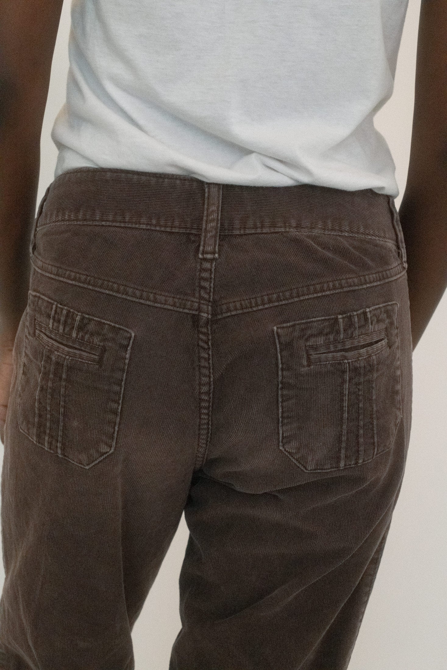 At the hem, a cuff detail whispers restraint, though the rich texture of corduroy begs to be touched.