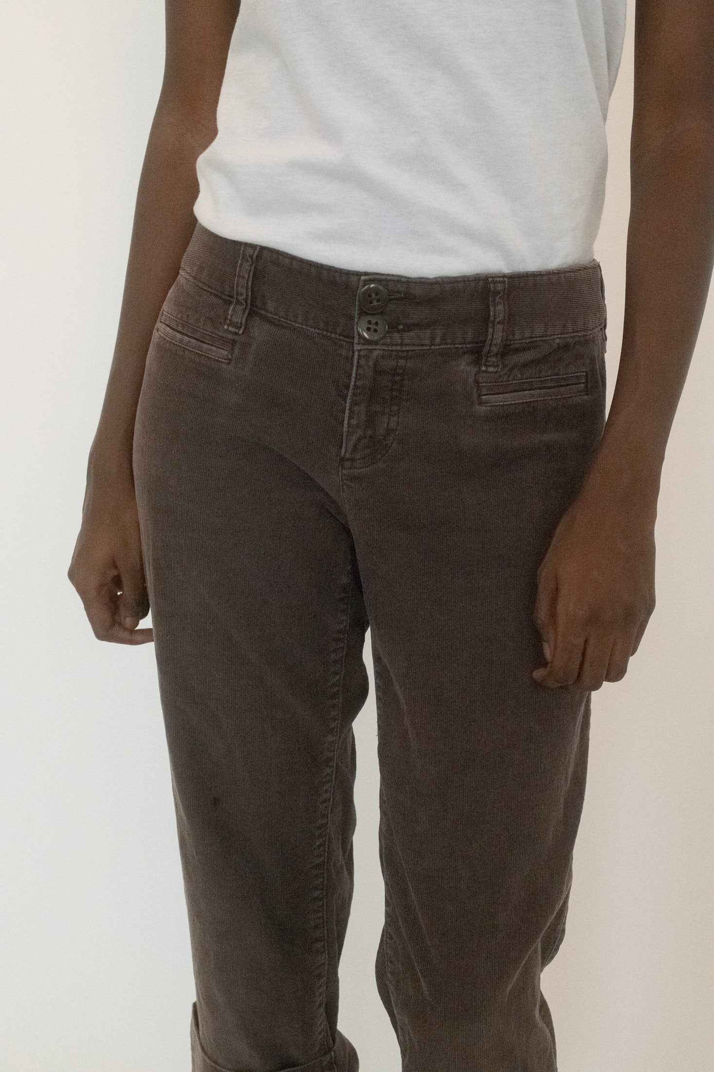 The low waist drops just enough to feel dangerous, with a zip fly and single button closure holding the line.