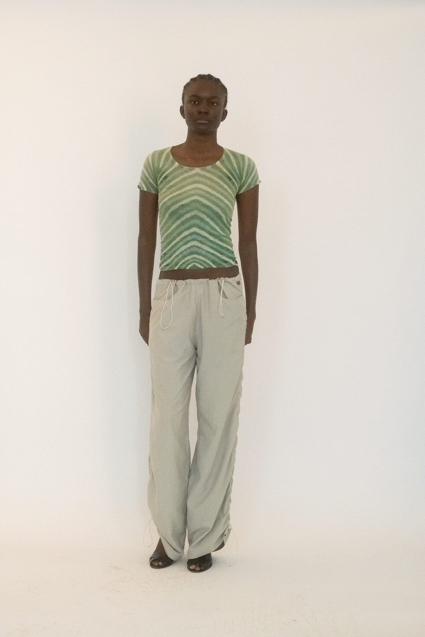 Made from thin, worn-in cotton, the fabric carries the patina of time, draping with the ease of true vintage.