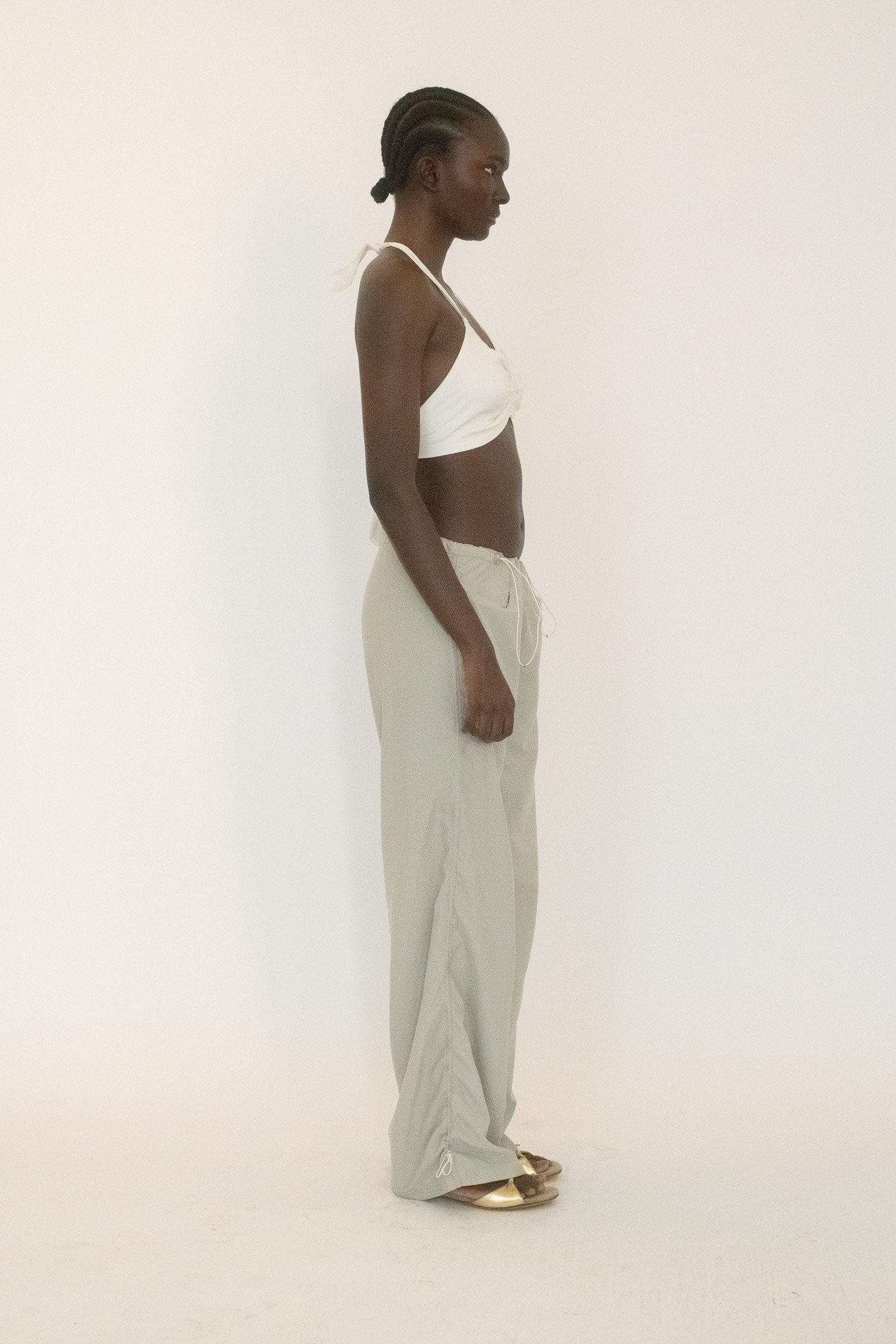 Cut in a pale sand shade that feels both muted and charged.