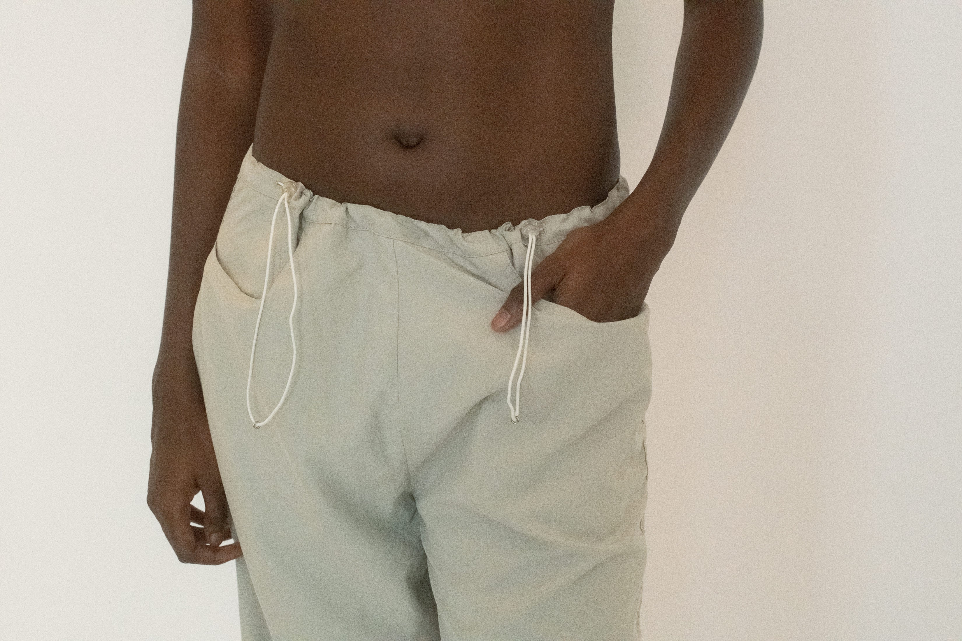 Front pockets keep it practical, but the fabric itself drapes with a softness that belies its tech edge, moving with you in a way that feels almost cinematic.